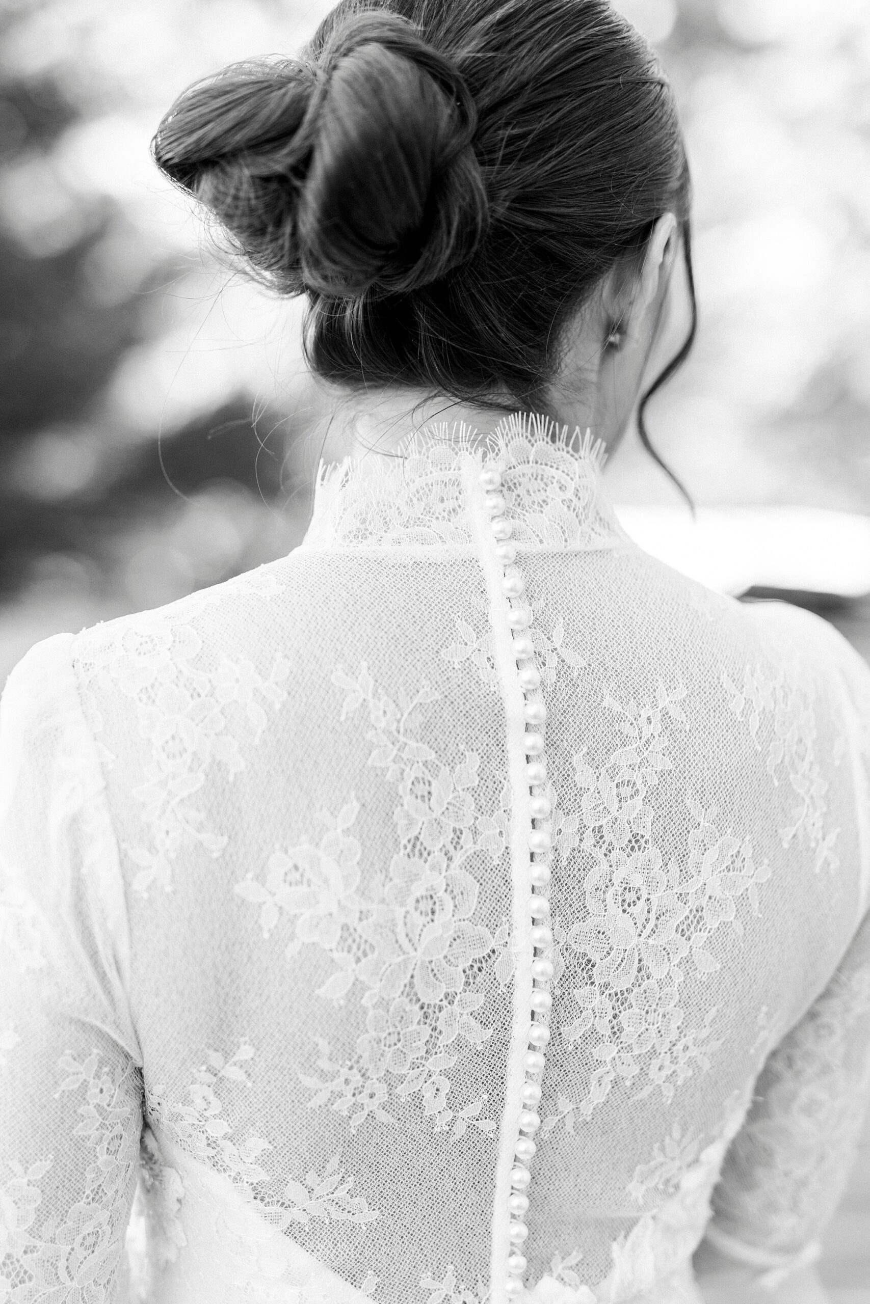 close up of bead detailing up bride's wedding gown back