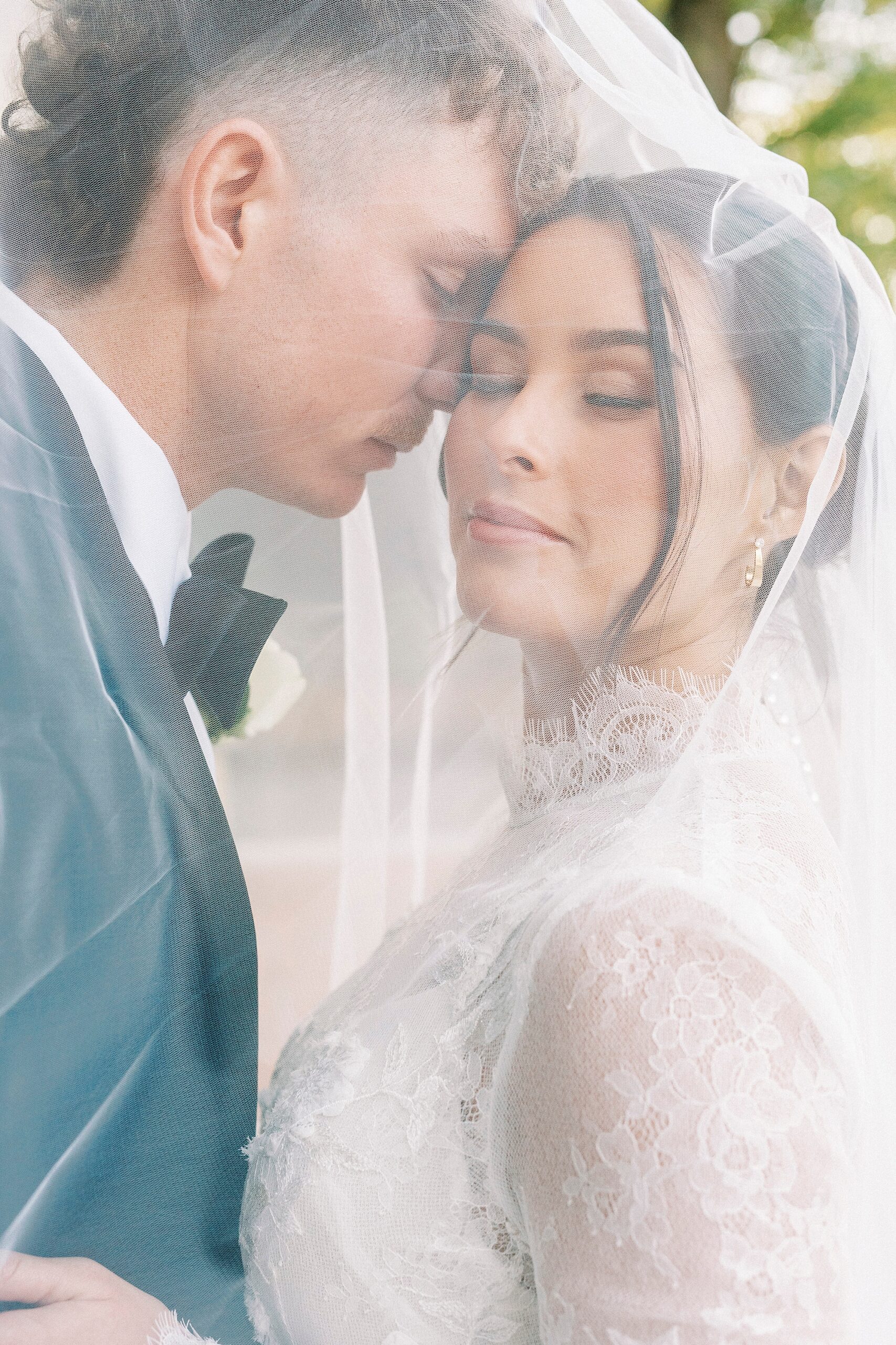 groom nuzzles bride's cheek under veil during Separk Mansion wedding photos