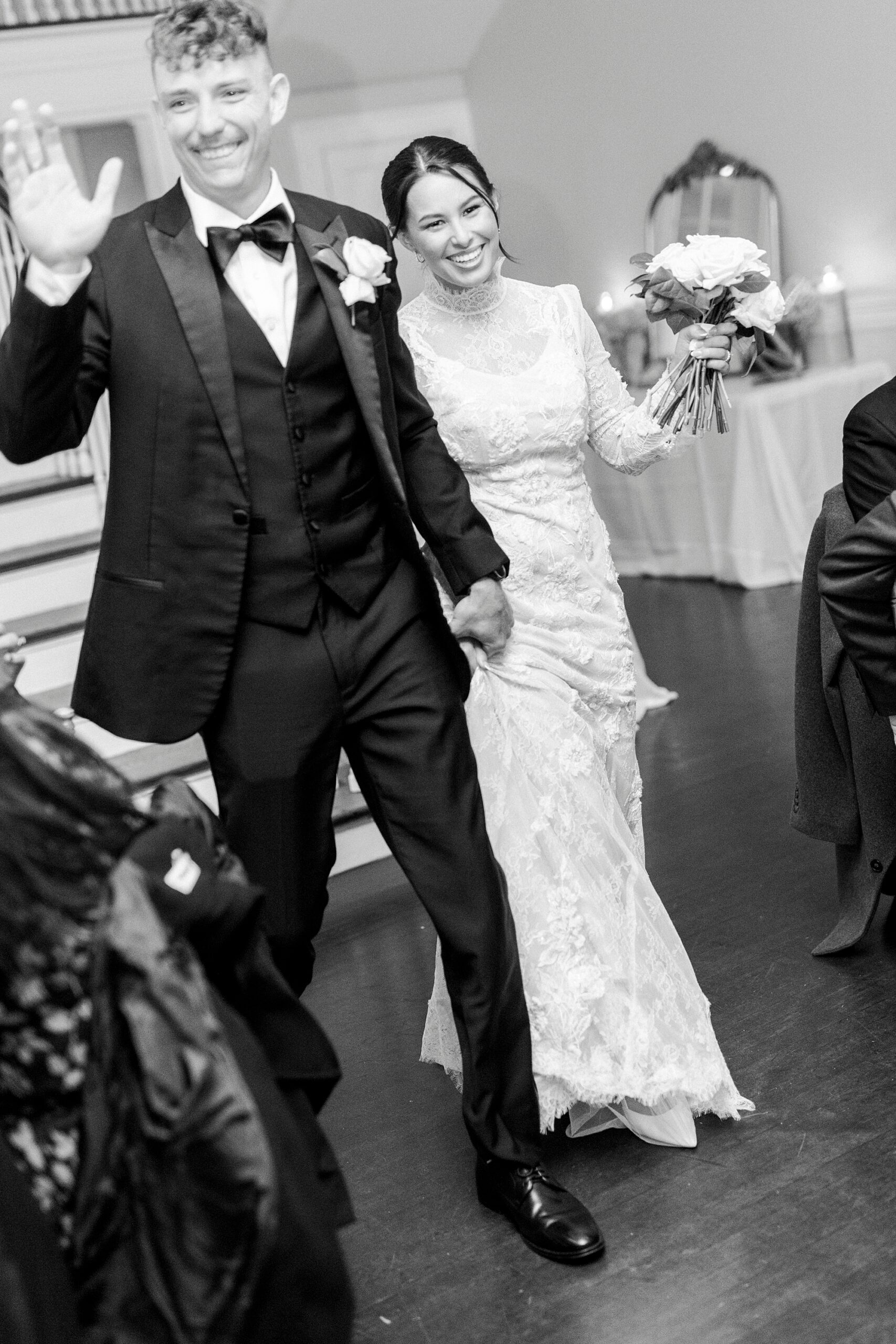 bride and groom grin holding hands walking into reception at Separk Mansion