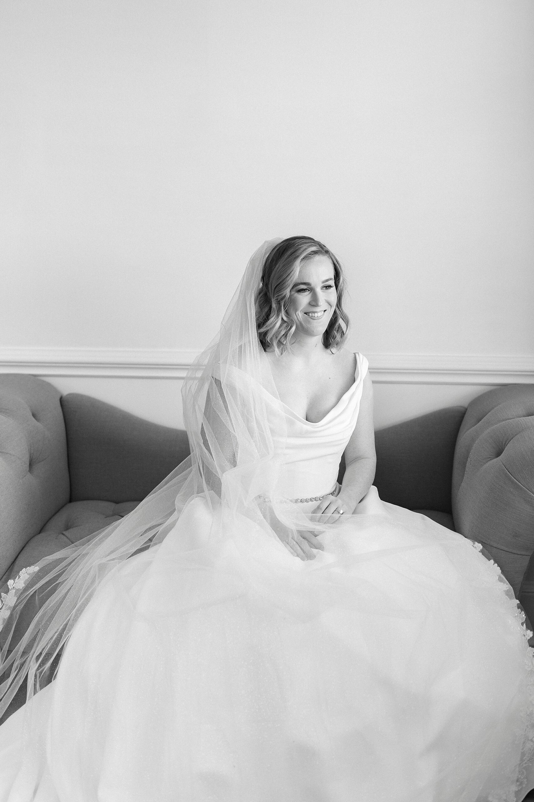 bride sits on sofa in bridal suite during portraits at Separk Mansion