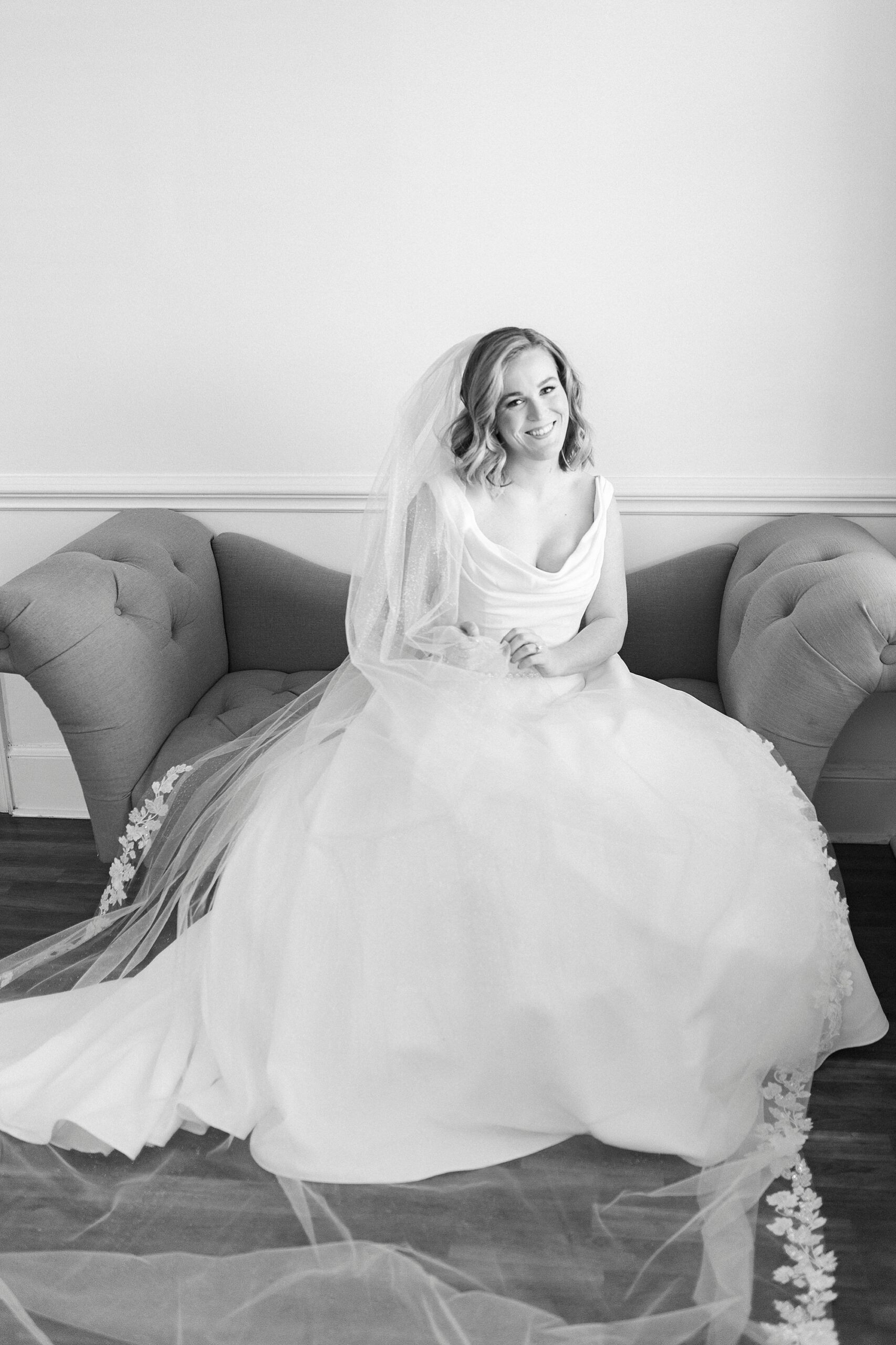 black and white portrait of bride sitting on sofa in suite at Separk Mansion