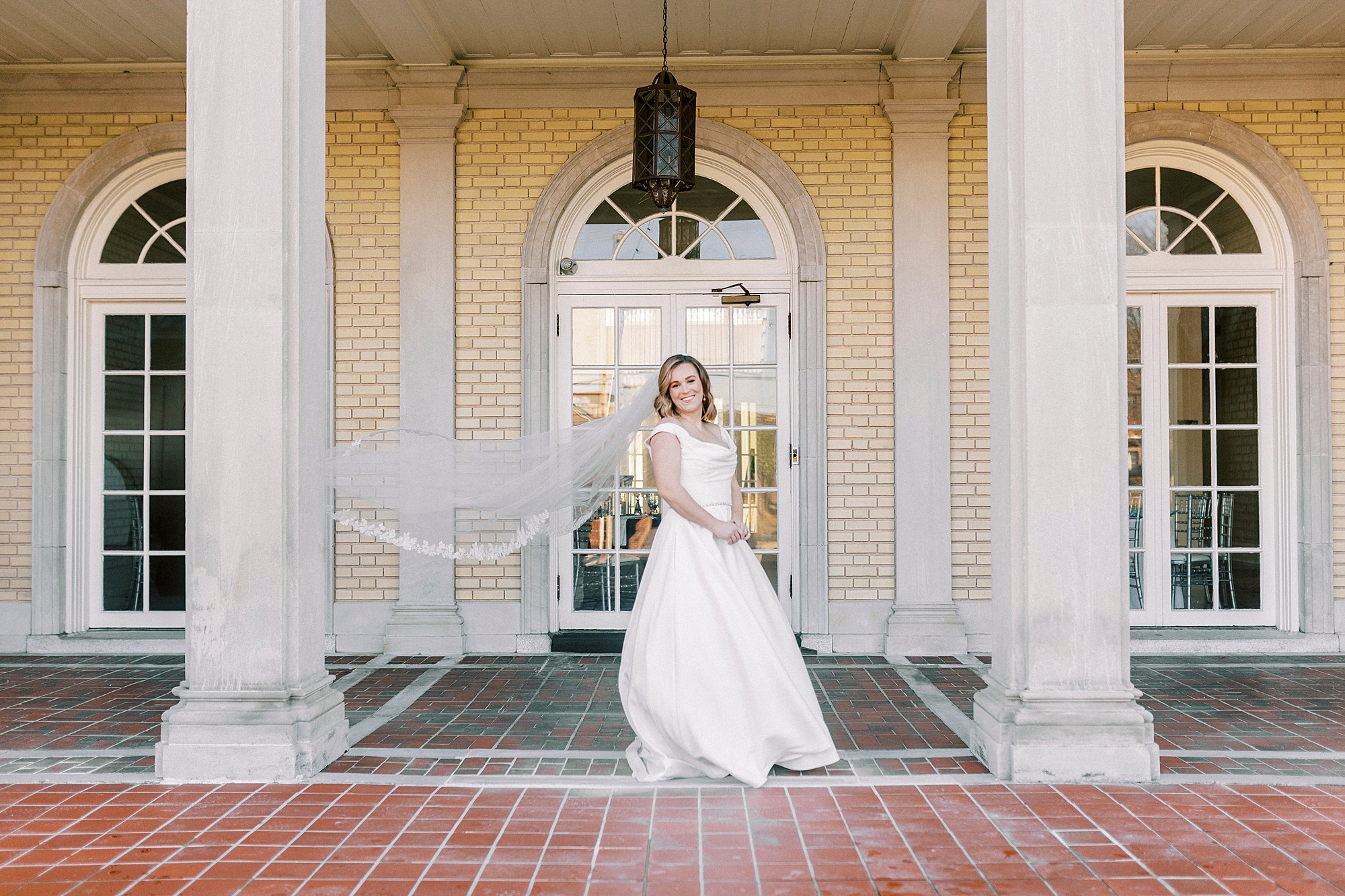 bride stands between pillars of Separk Mansion