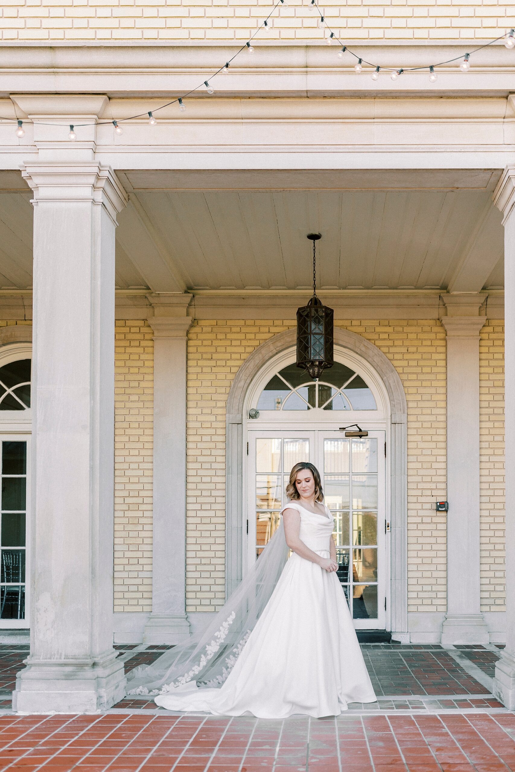 bride stands outside Separk Mansion under black light