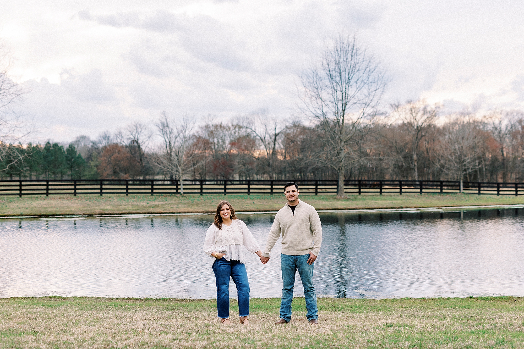 man and woman hold hands in front of pond at Morning Glory Farm
