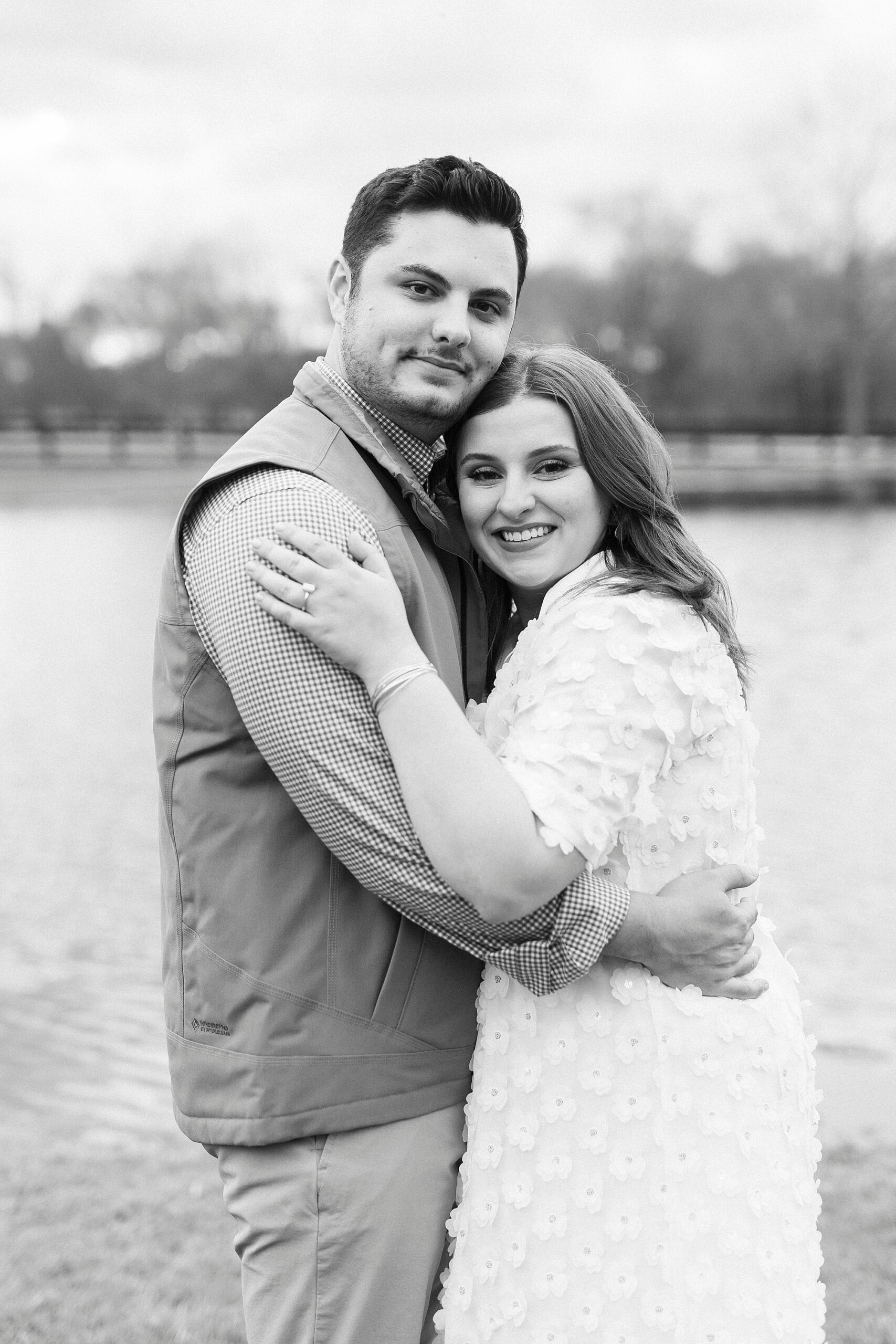 woman and man hug together next to pond at Morning Glory Farm