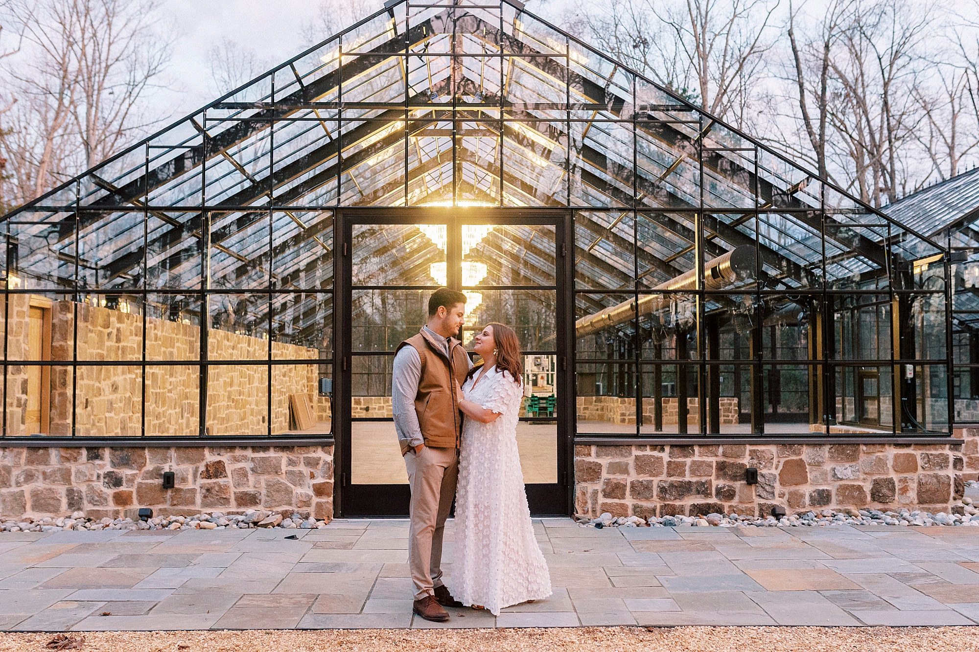 man and woman hug outside greenhouse at Morning Glory Farm