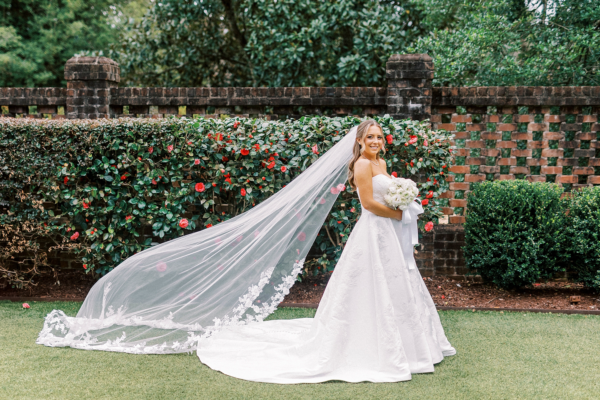bride stands in gardens at the Sutherland in Wake Forest NC