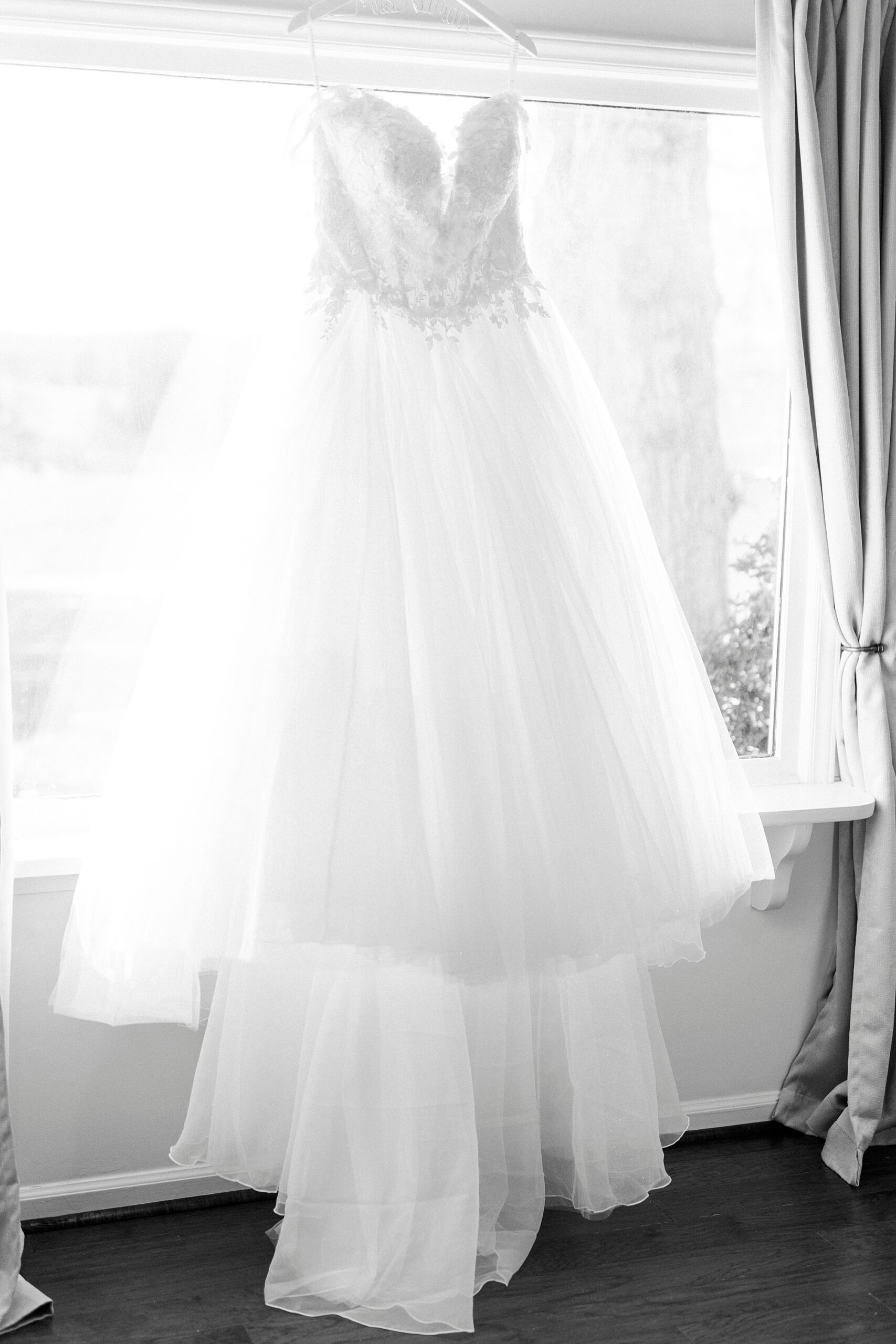 wedding dress hangs in suite at Summerfield Farms