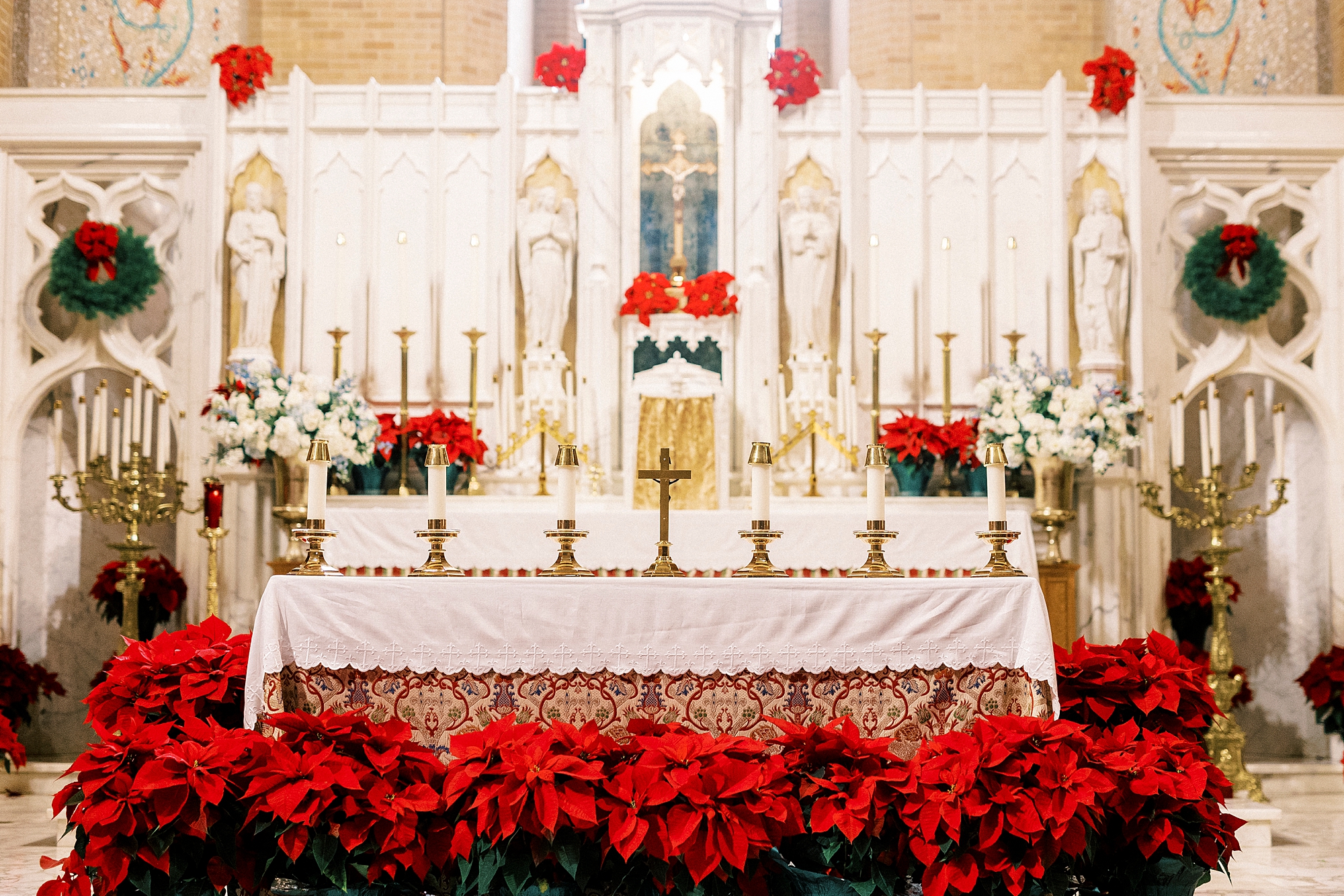 alter covered in red poinsettias inside Our Lady of Grace in Greensboro NC