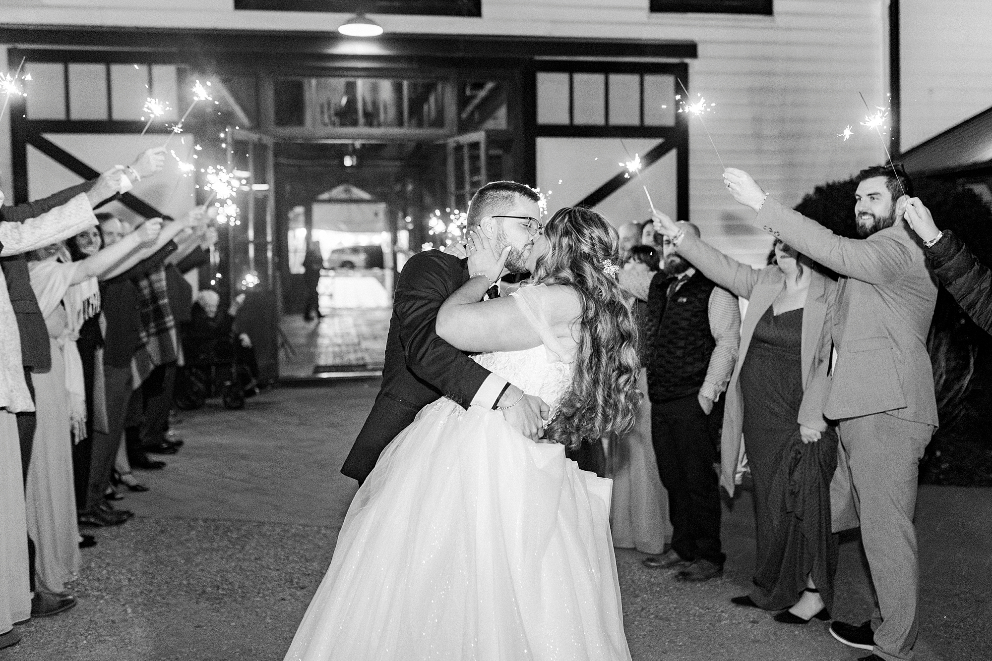 bride and groom kiss during sparkler exit from Summerfield Farms