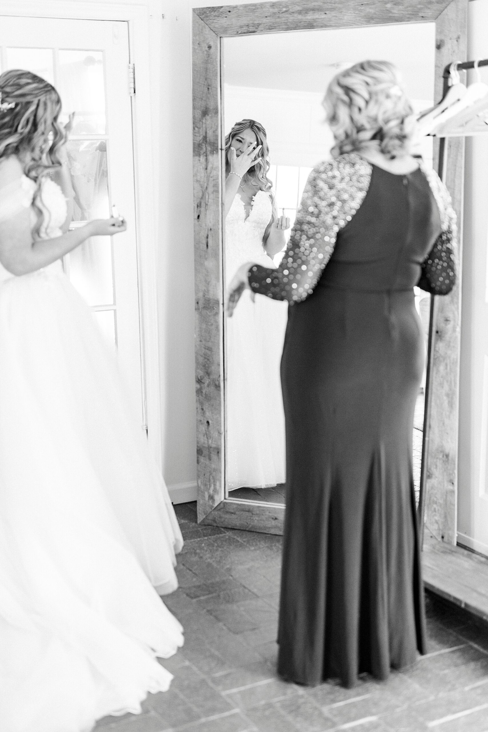 bride and mom talk in mirror in bridal suite at Summerfield Farms