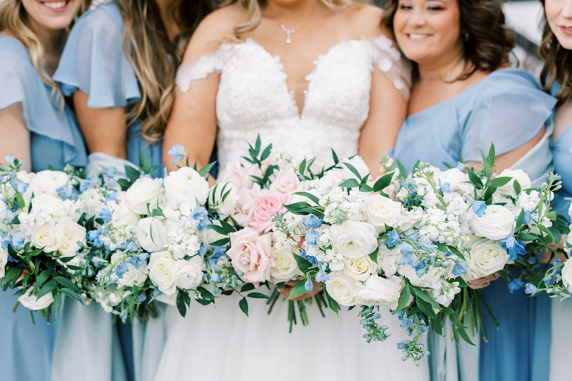 bride and bridesmaids hold light pastel bouquets for winter weddings at Summerfield Farms
