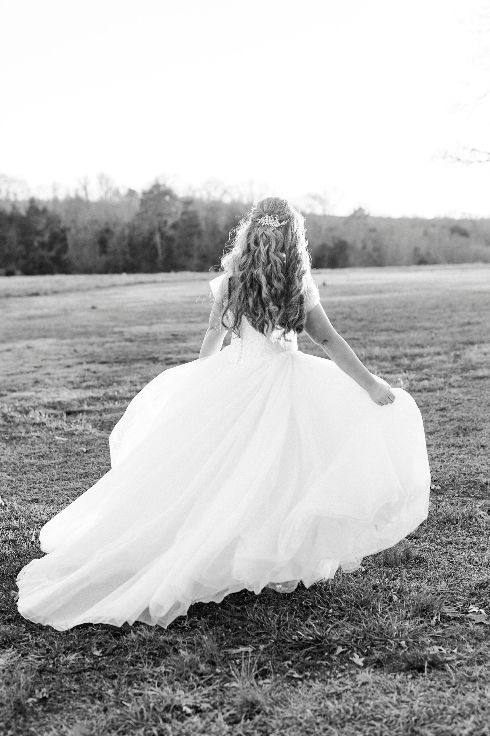 bride runs across lawn in wedding gown at Summerfield Farms