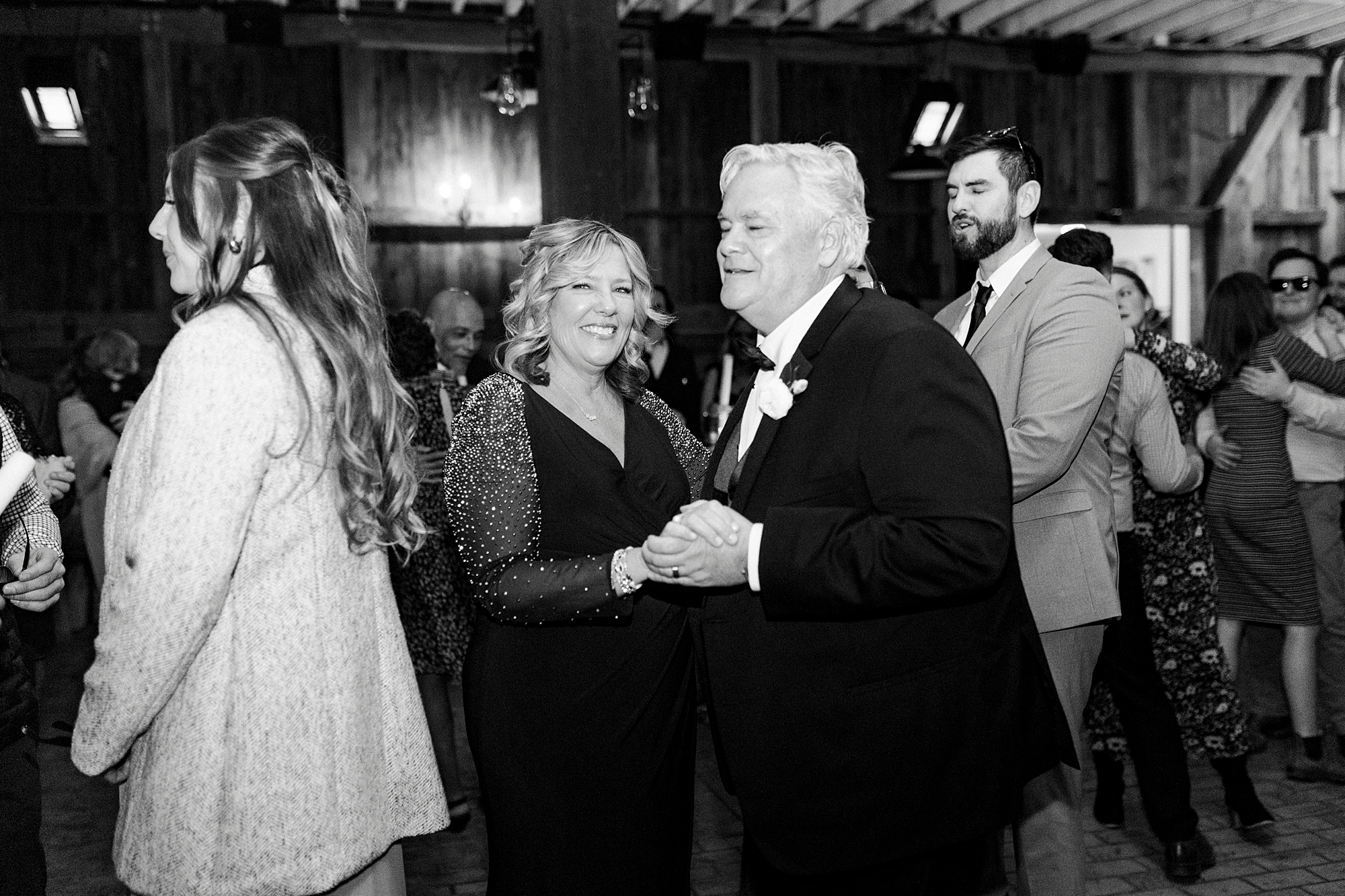 parents dance during wedding reception in barn at Summerfield Farms