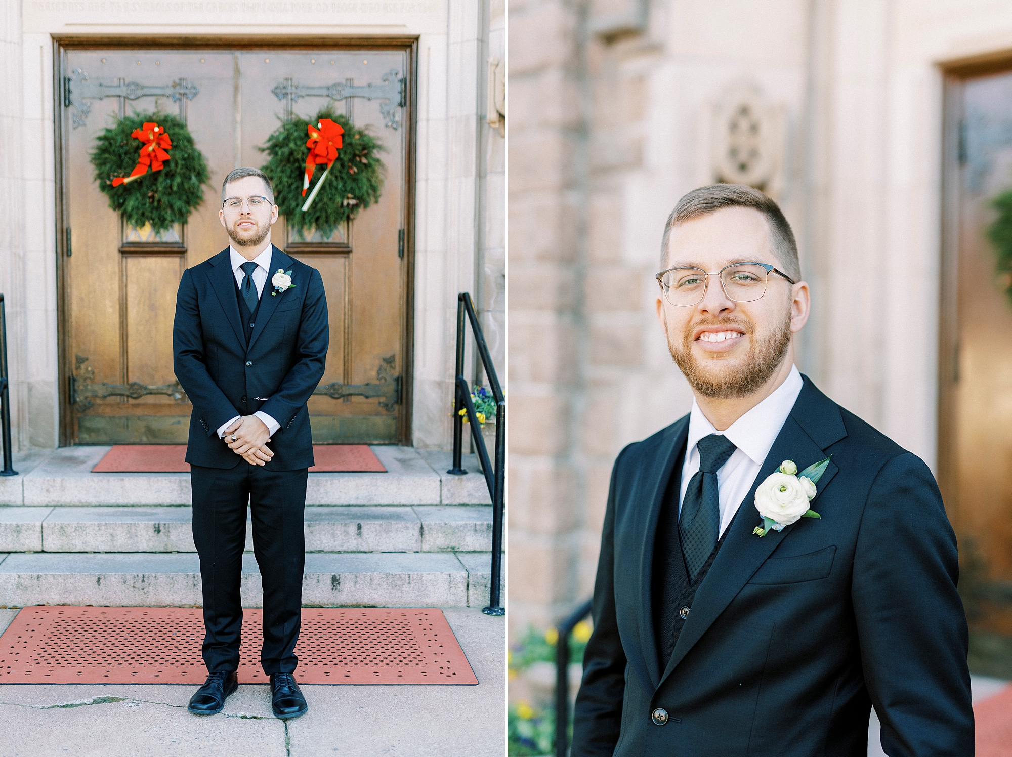 groom stands outside wooden doors of Our Lady of Grace with wreaths hanging on the outside