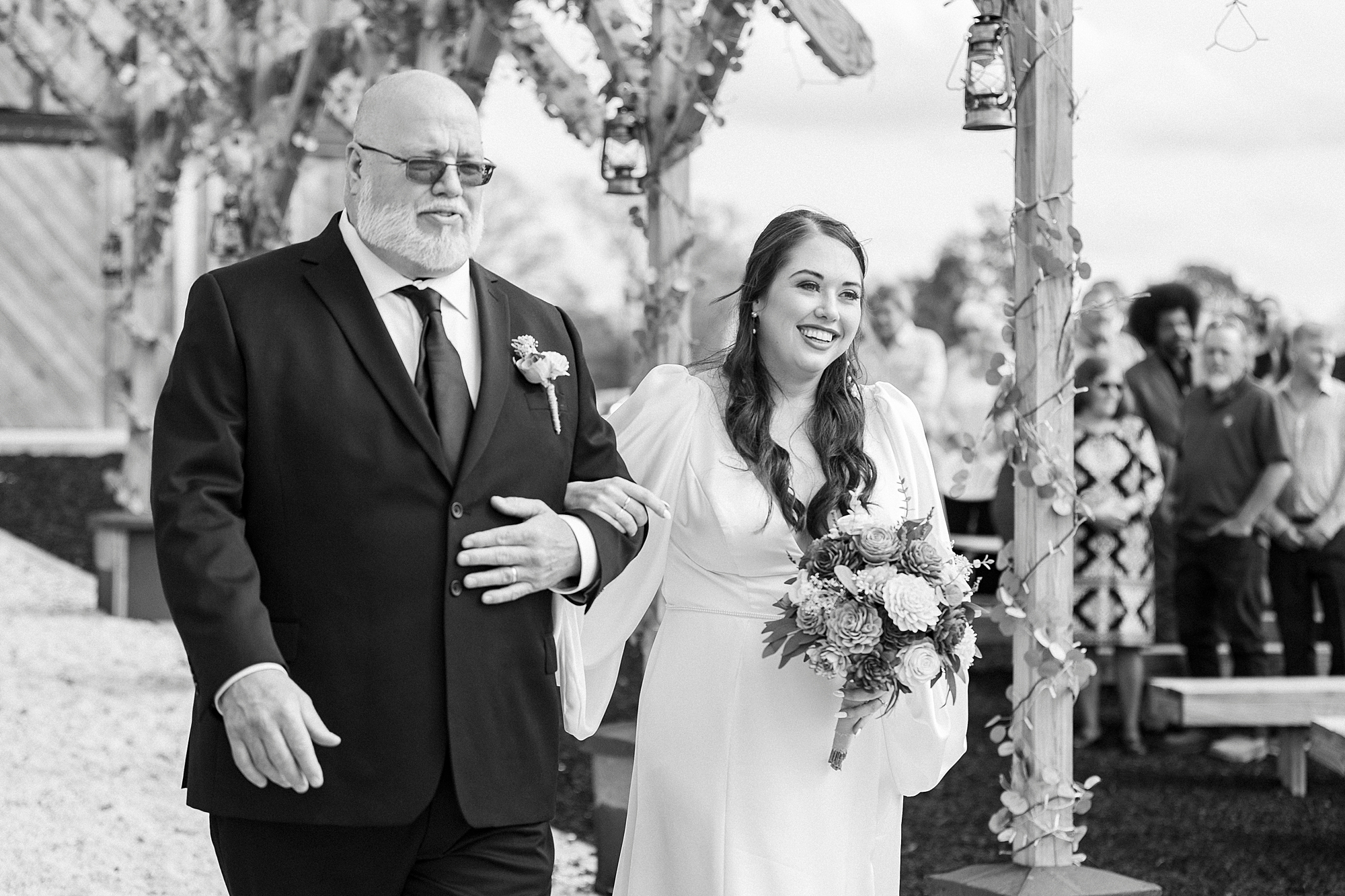 father escorts bride down aisle for ceremony at Sixty Acres Farm