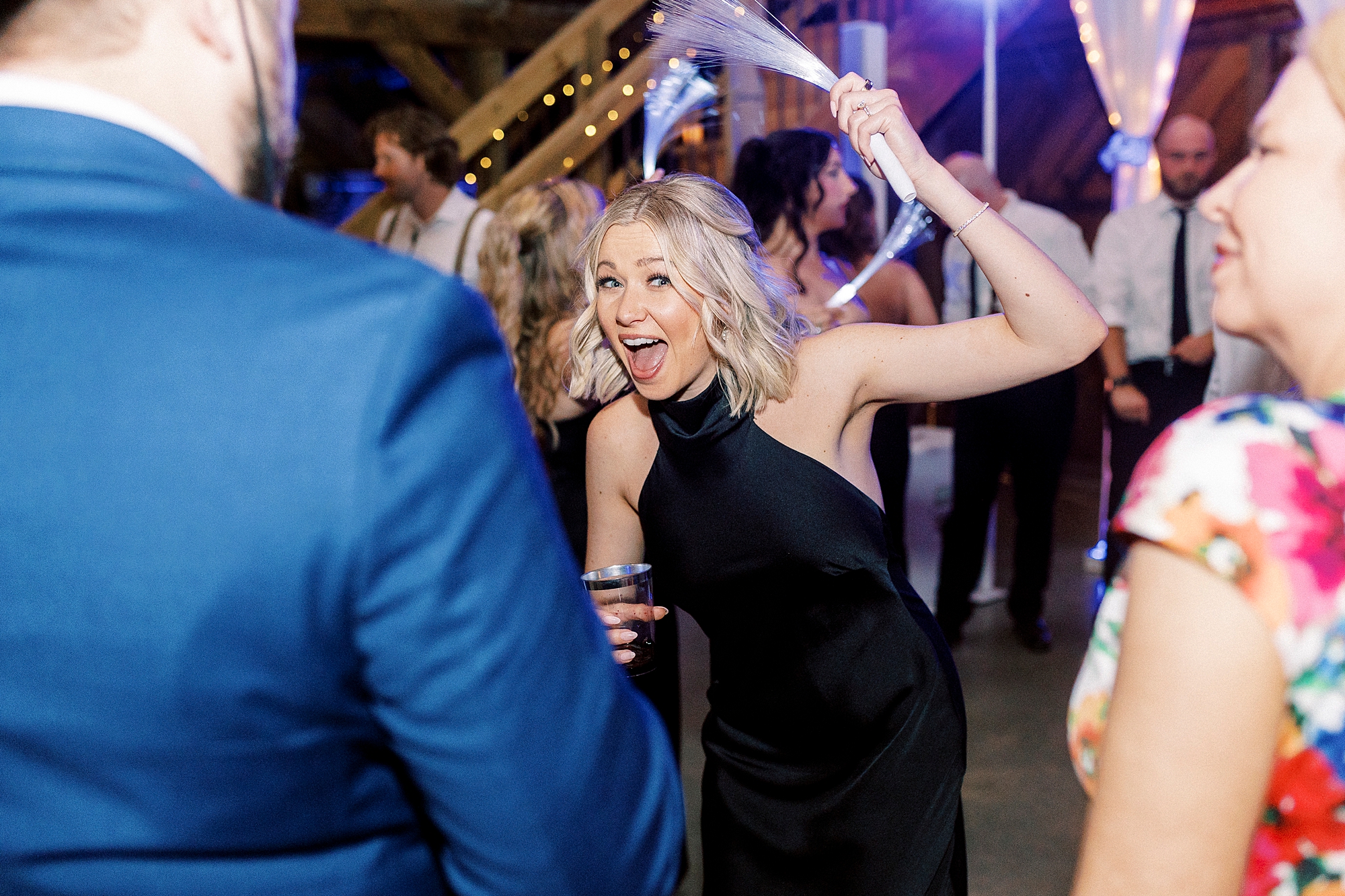 wedding guest dances with glow stick at during wedding reception in Mount Pleasant NC