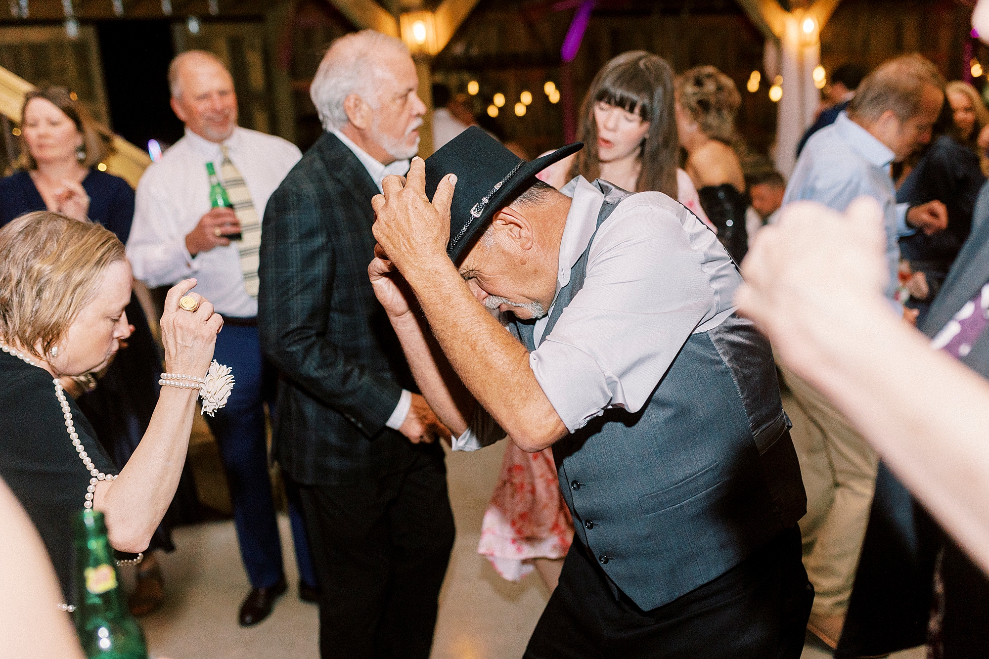 guest tips cowboy hat on dance floor during during wedding reception in Mount Pleasant NC