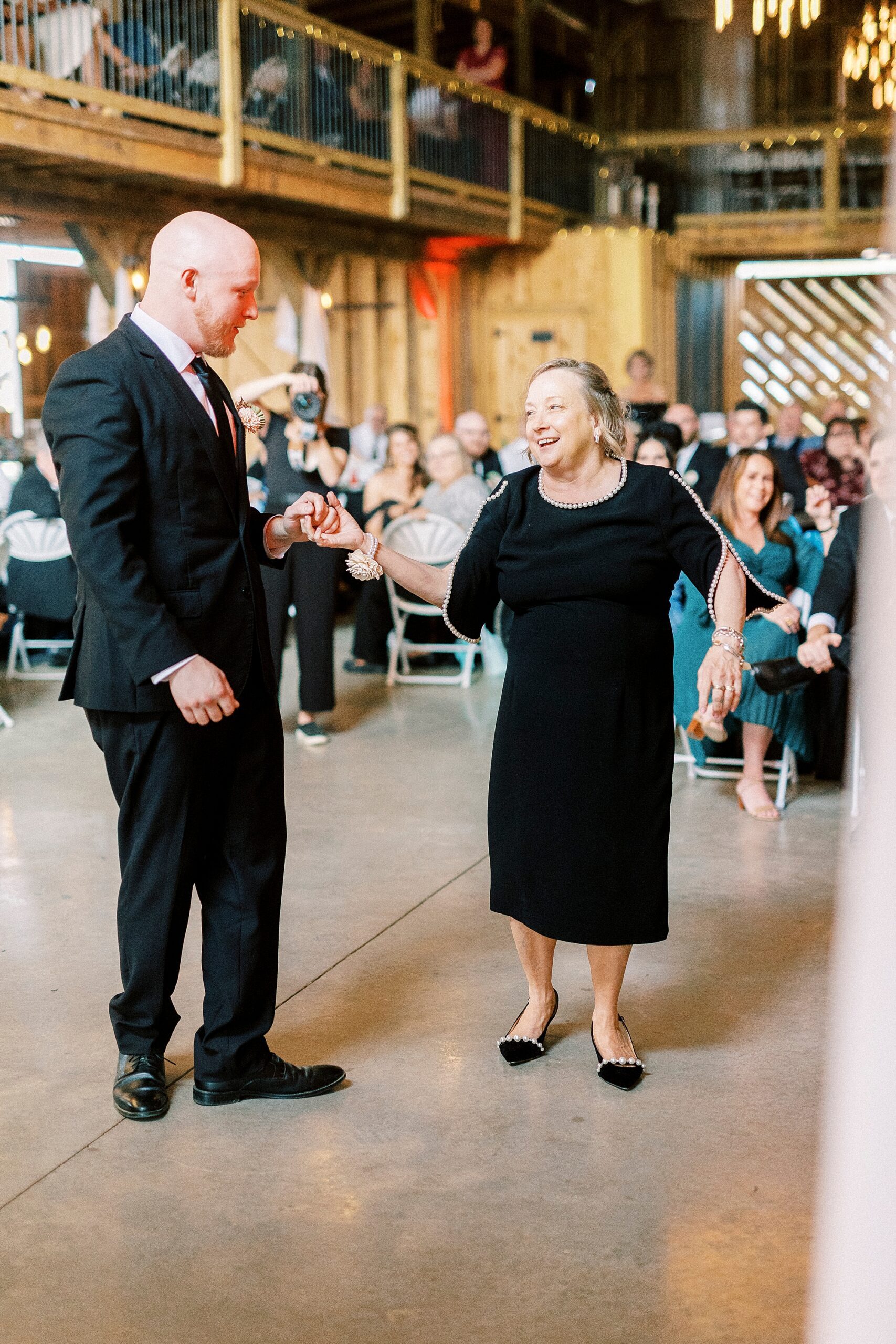groom and mom stand together on dance floor at during wedding reception in Mount Pleasant NC