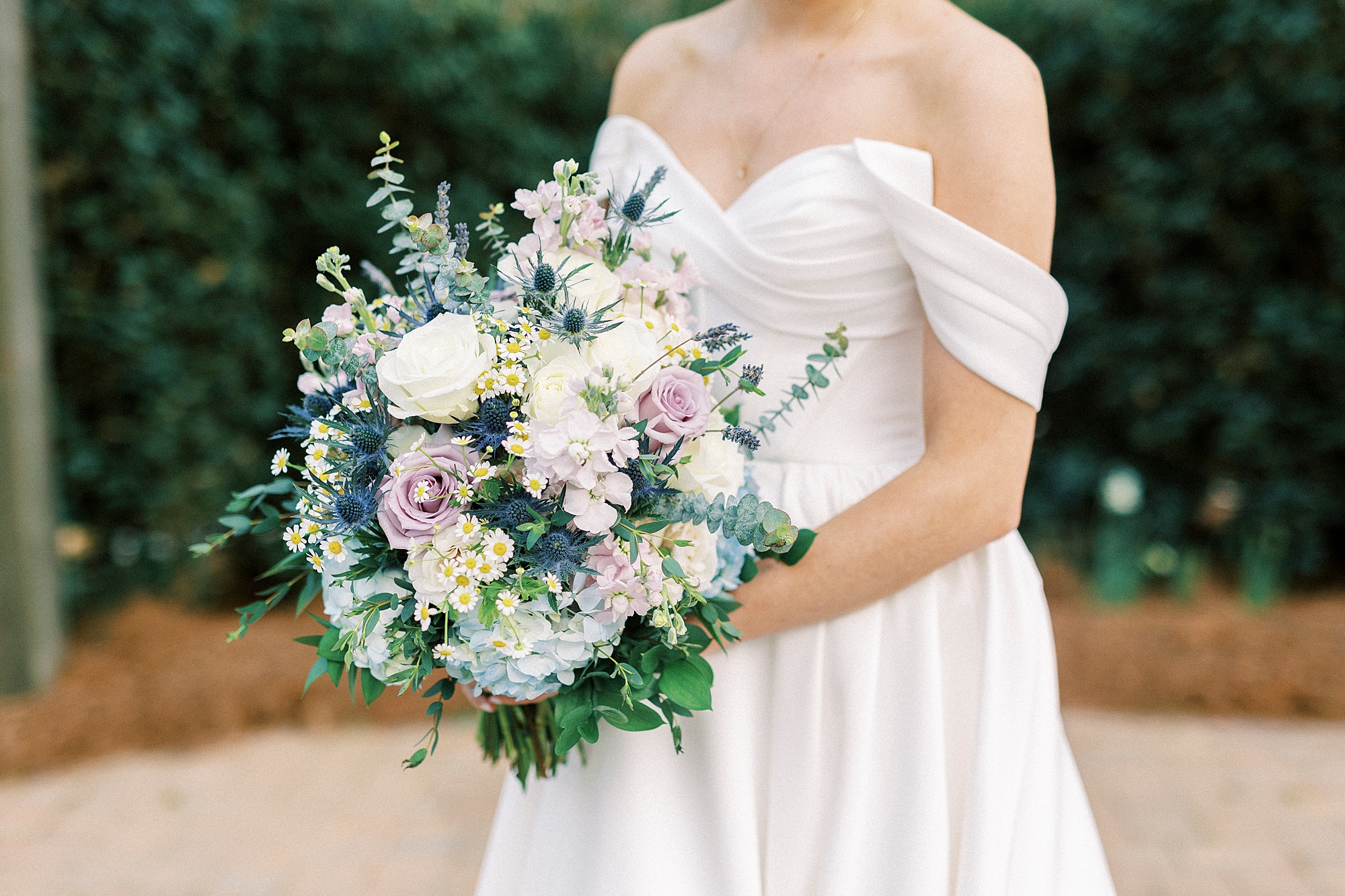 closeup of spring bridal bouquet with white and purple flowers 
