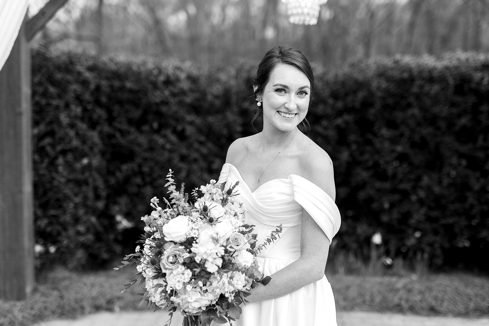 black and white photo of bride holding bouquet at Low Meadows Estate