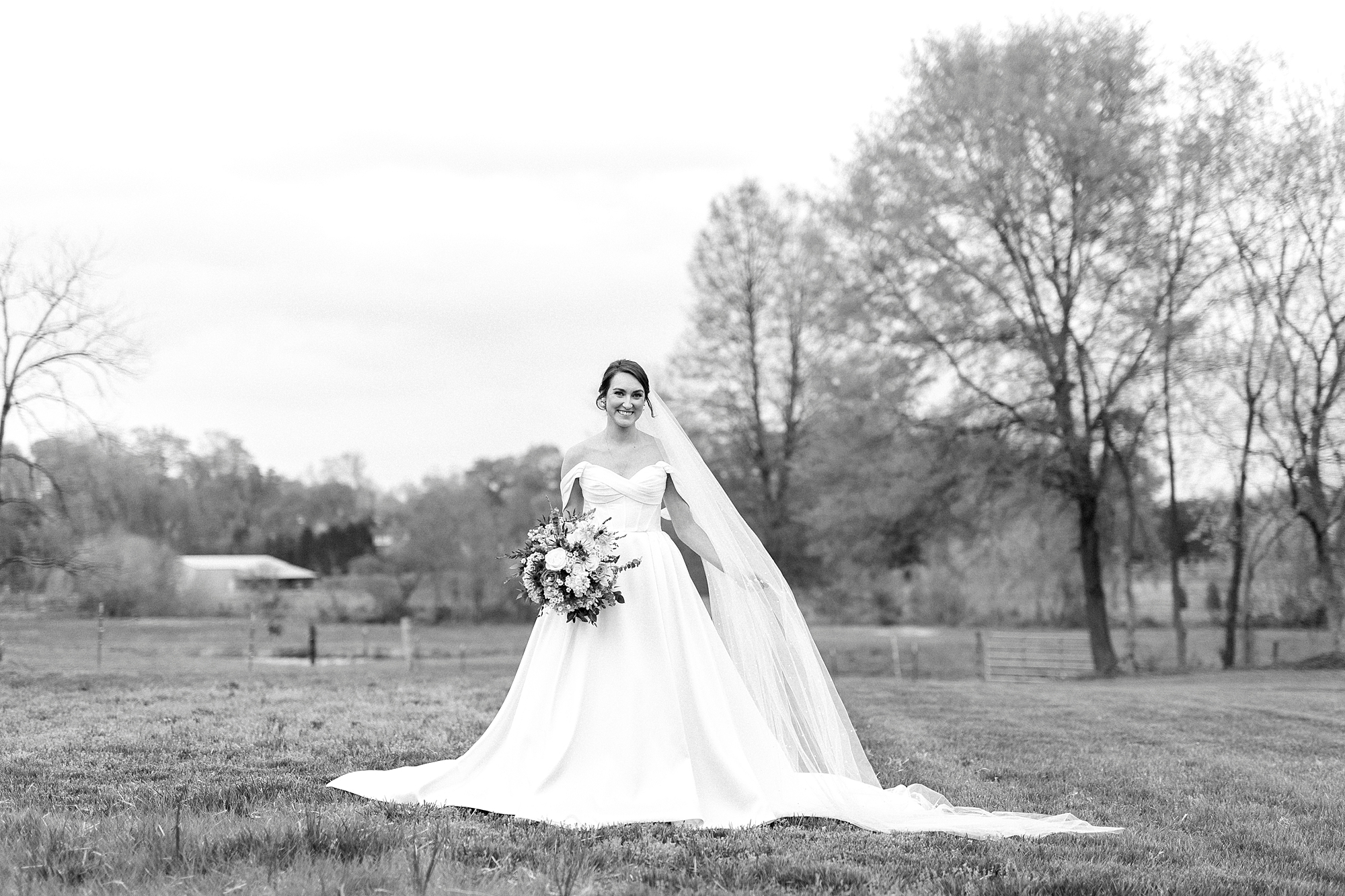 black and white of bride standing on lawn at Low Meadows Estate