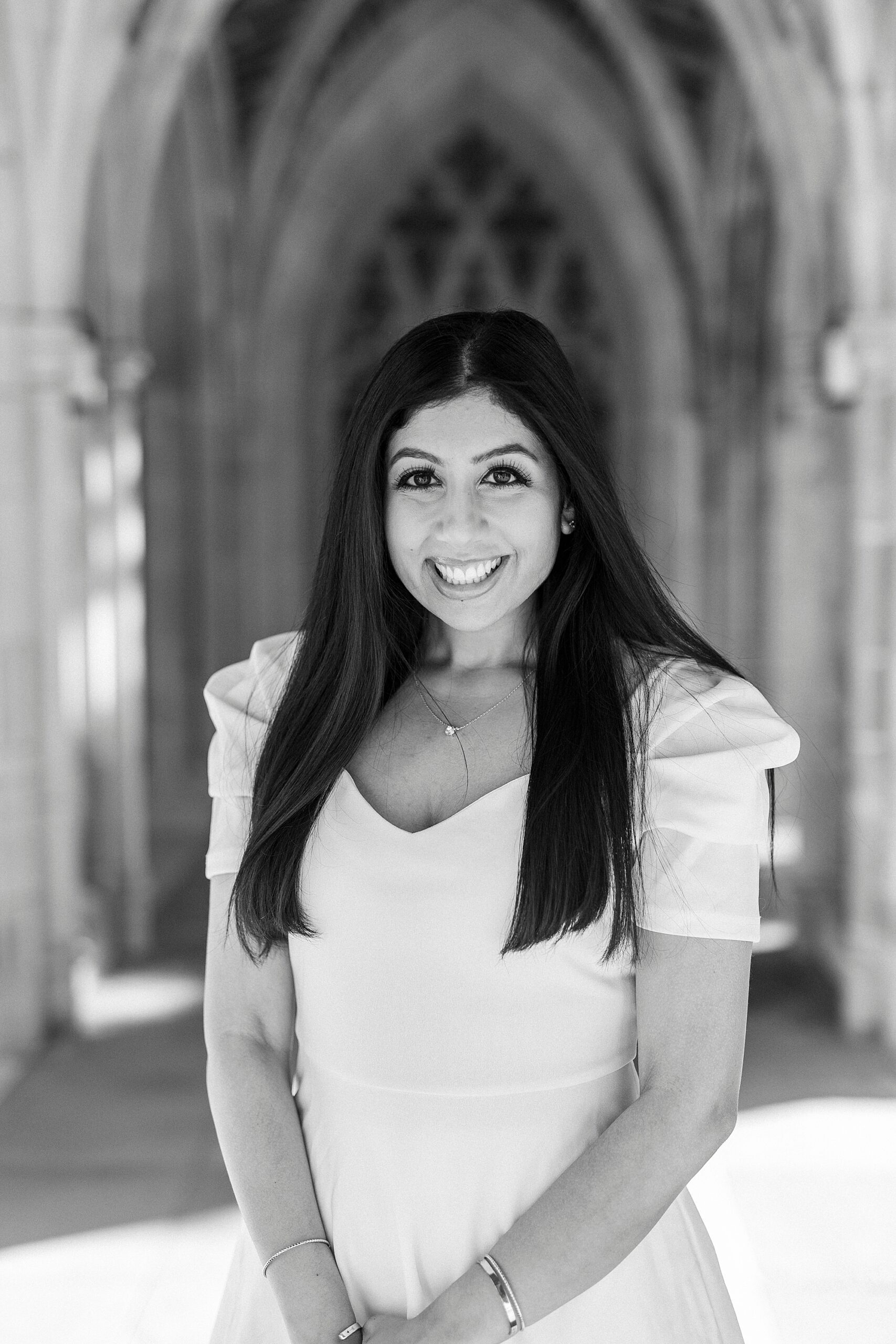 black and white portrait of woman outside Duke Chapel in white dress