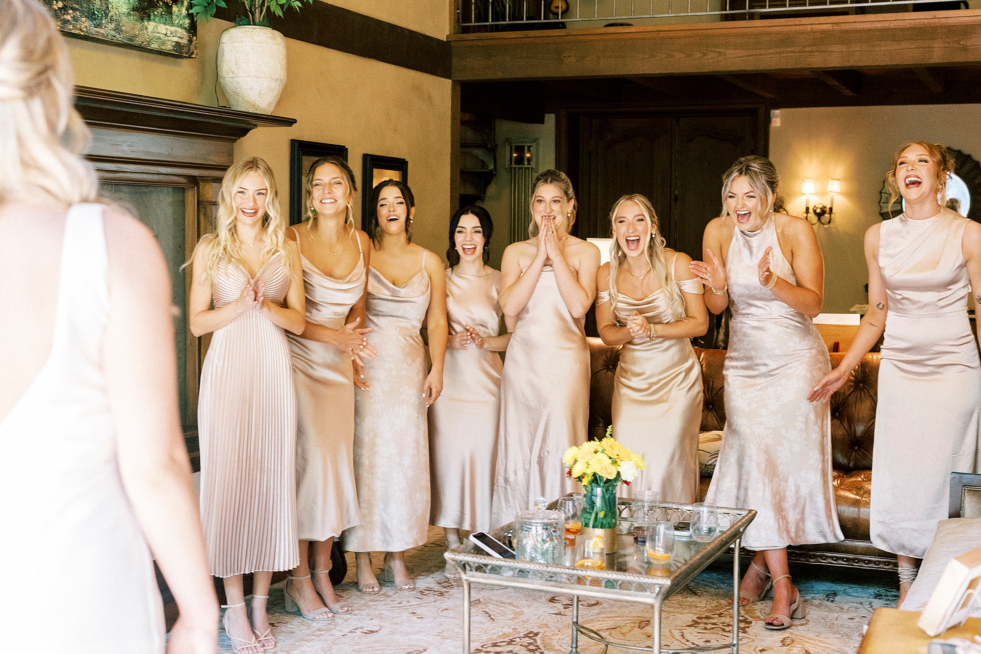 bridesmaids react to seeing bride in wedding gown