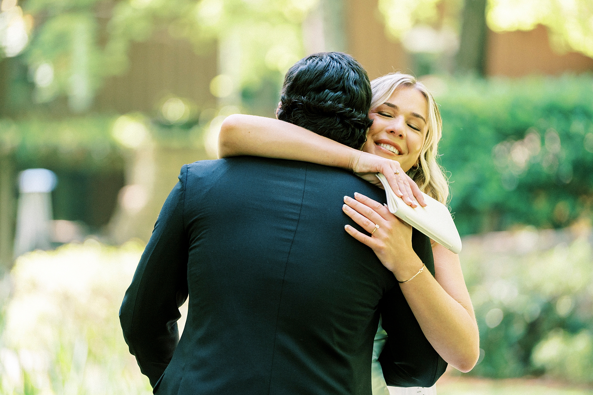 bride hugs groom tight during first look in garden at Morning Glory Farm