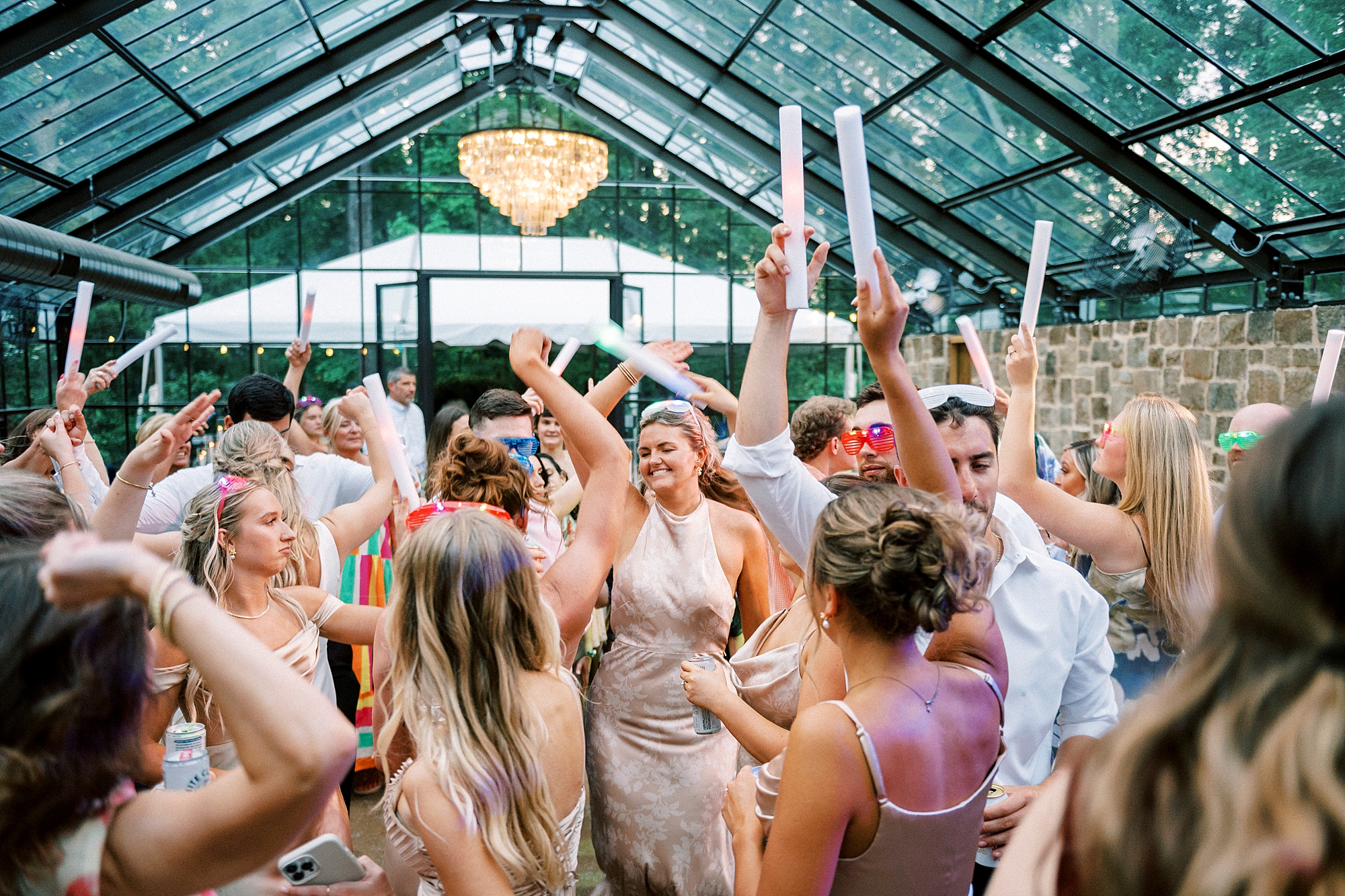 wedding guests dance with glow sticks during NC wedding reception at Morning Glory Farm