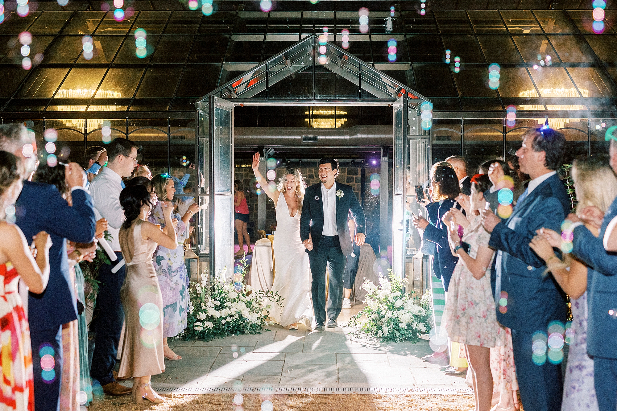 newlyweds cheer during bubble exit from Morning Glory Farm