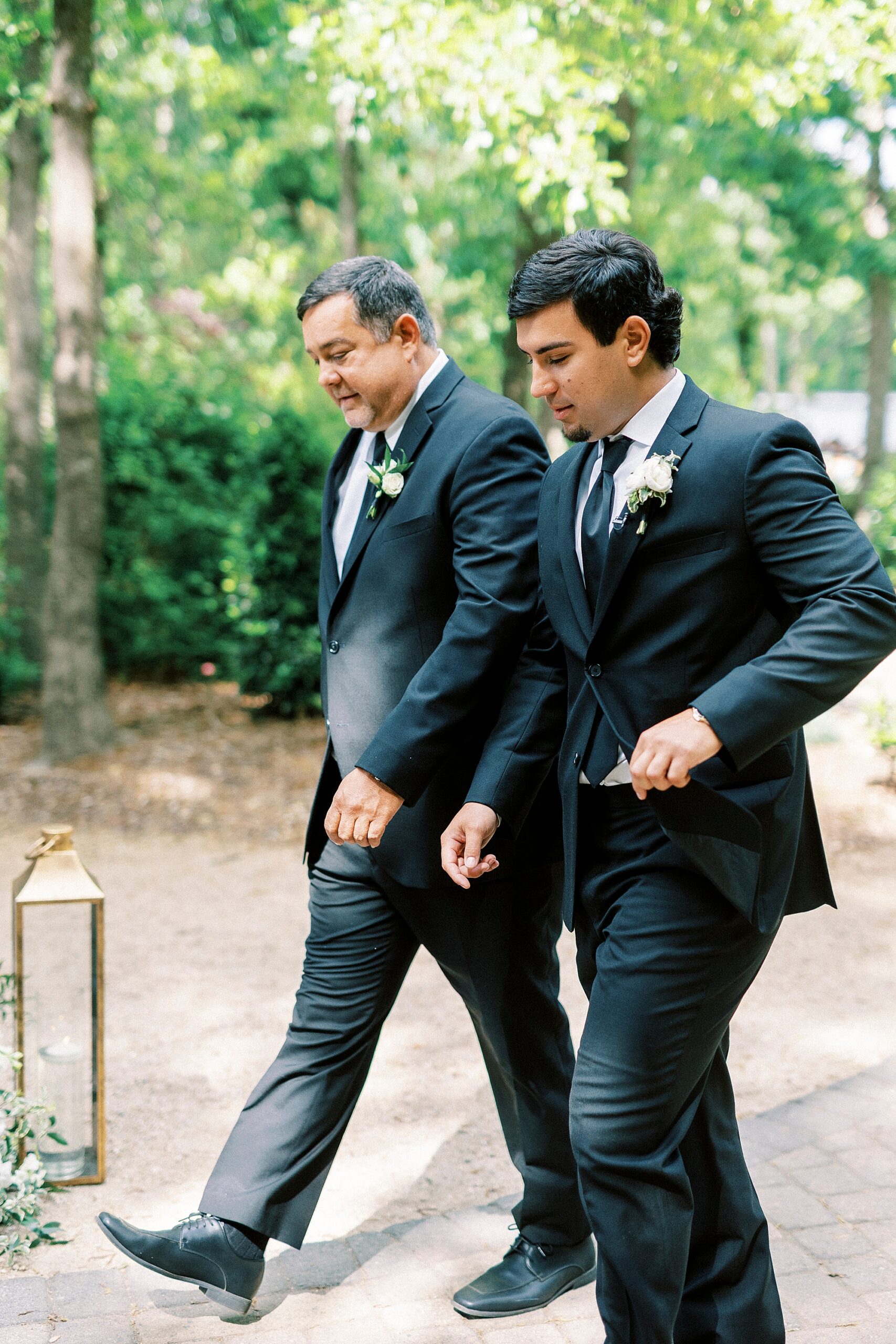 groom walks with father to ceremony site