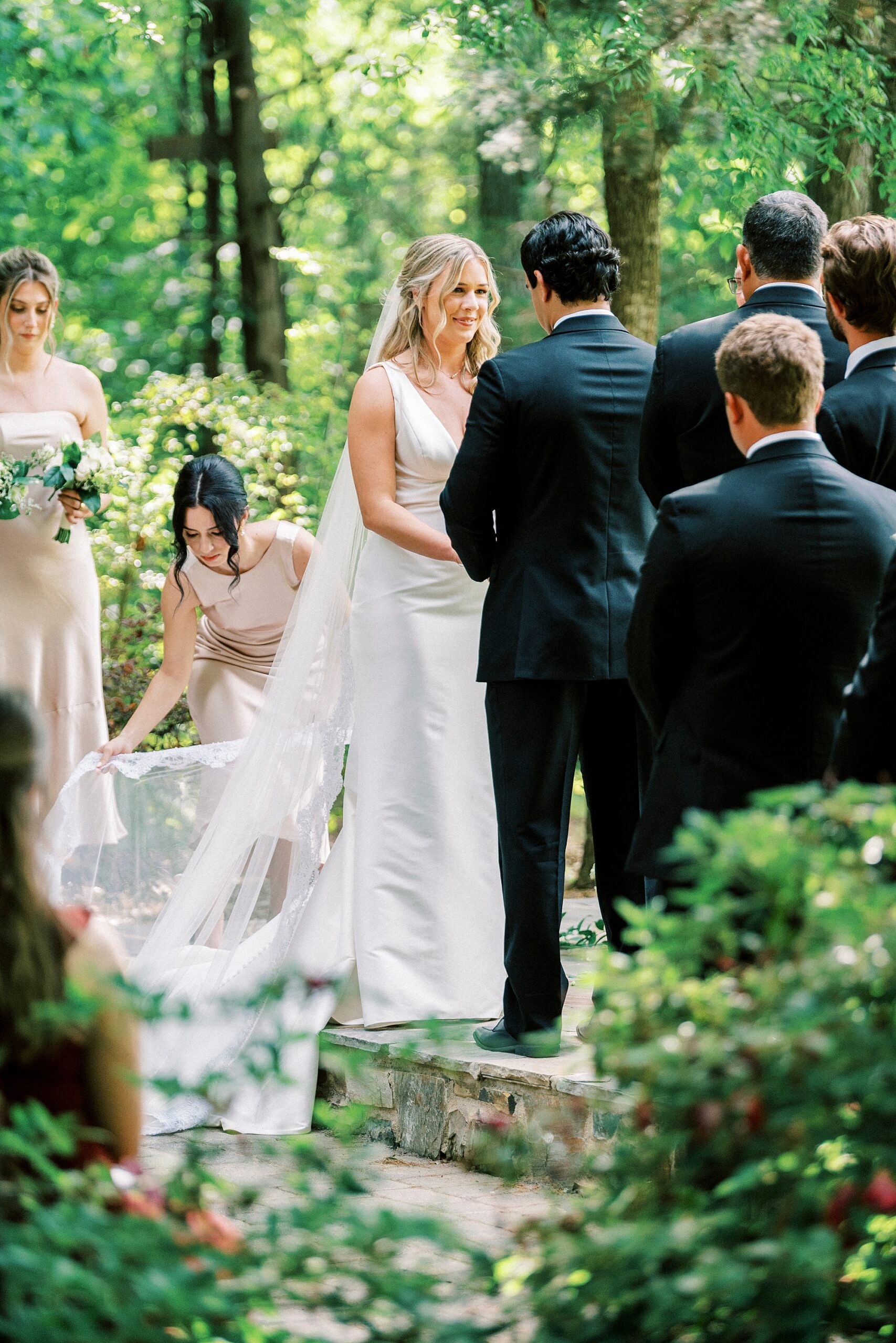 bride holds hands with groom during ceremony at Morning Glory Farm