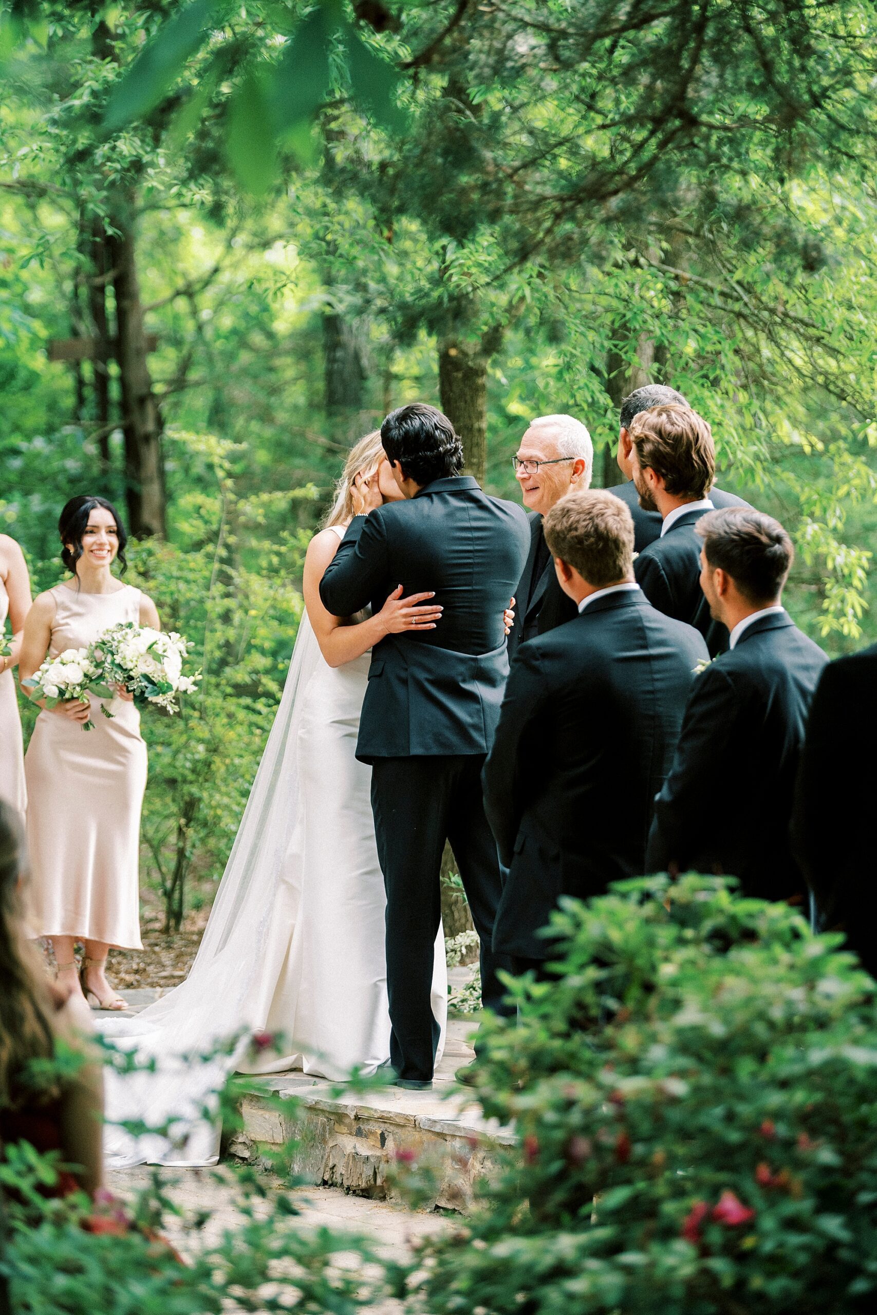 newlyweds kiss during wedding ceremony at Morning Glory Farm