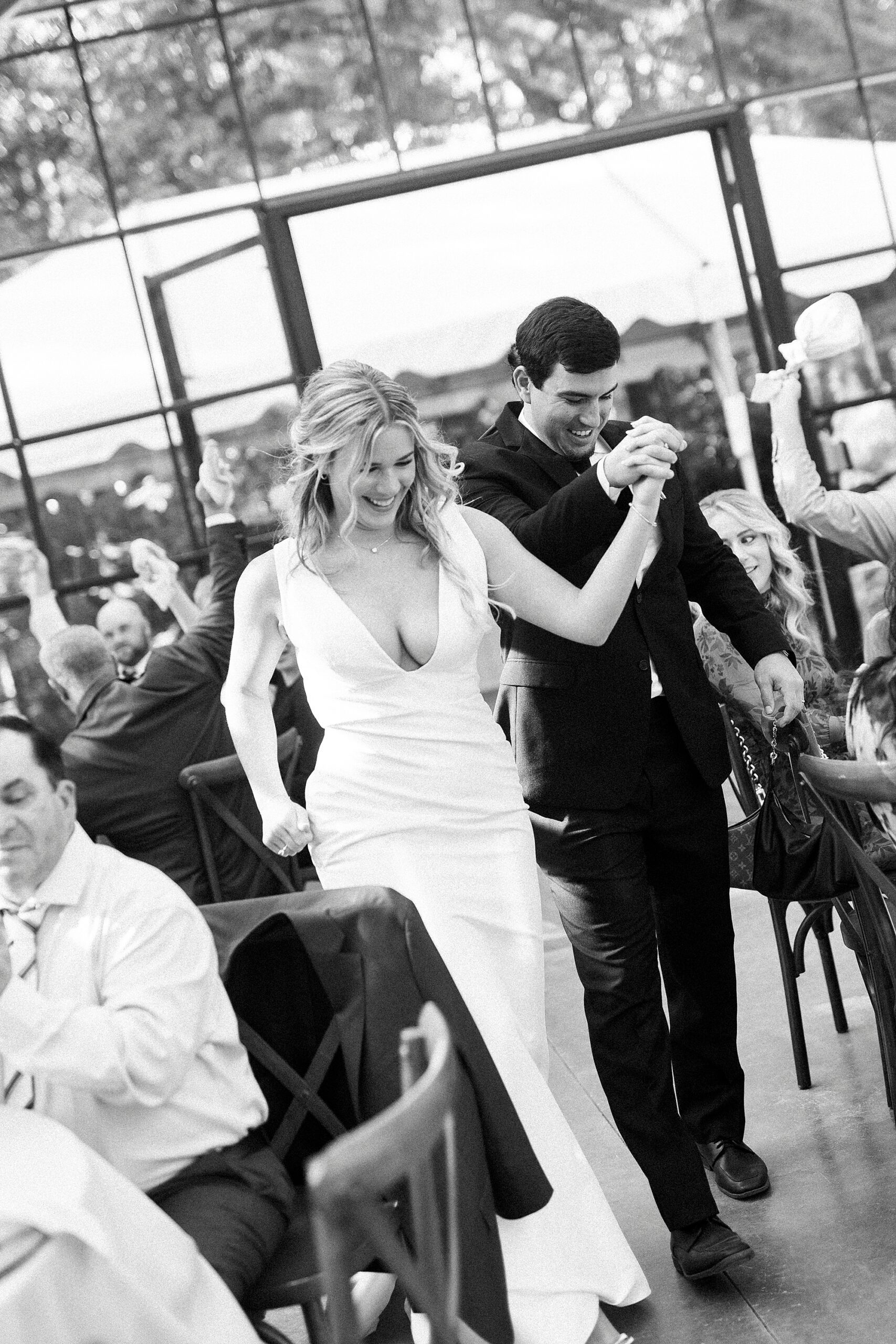 bride and groom hold hands walking into reception at Morning Glory Farm