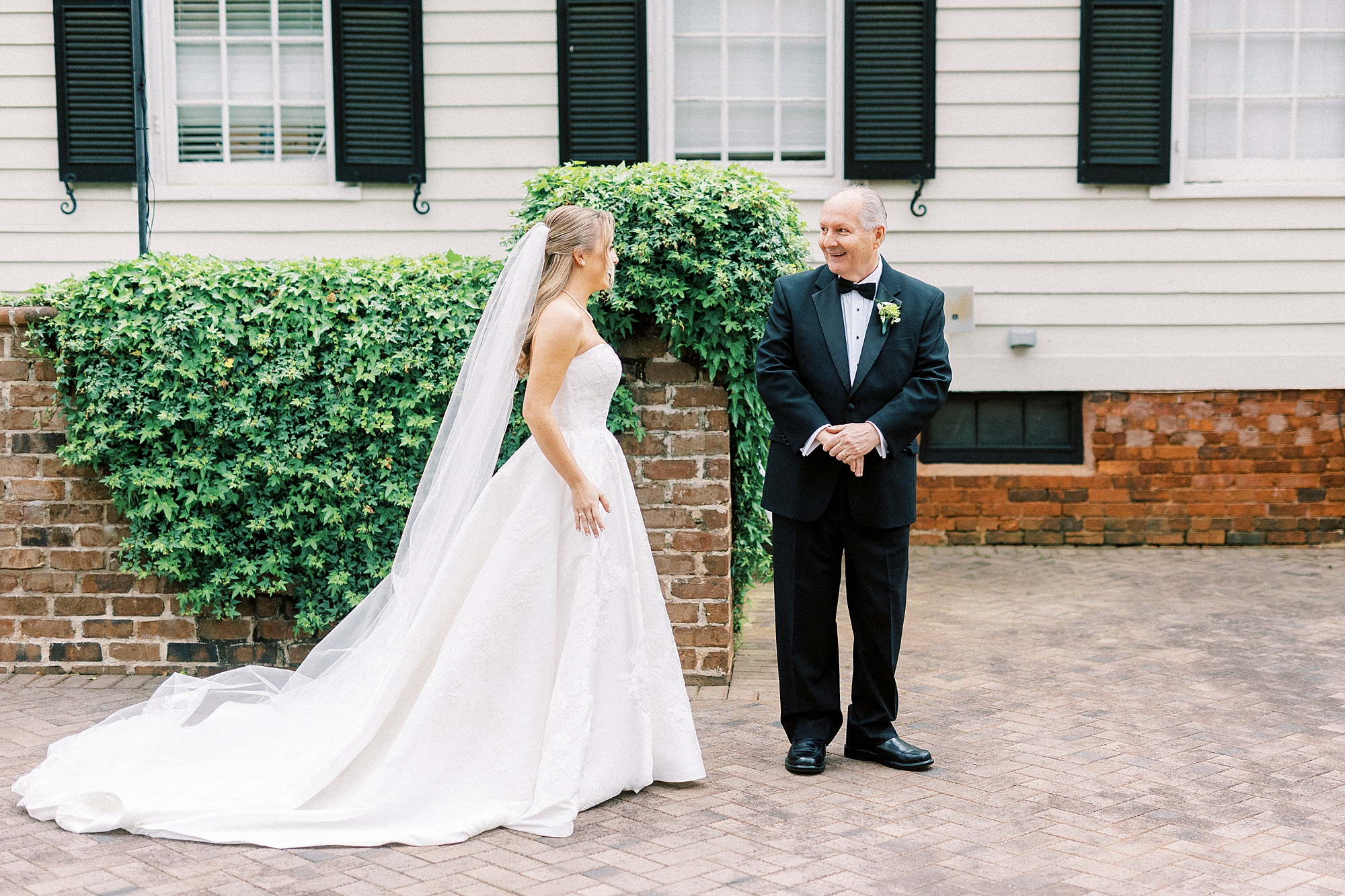 bride approaches father for first look outside the Sutherland