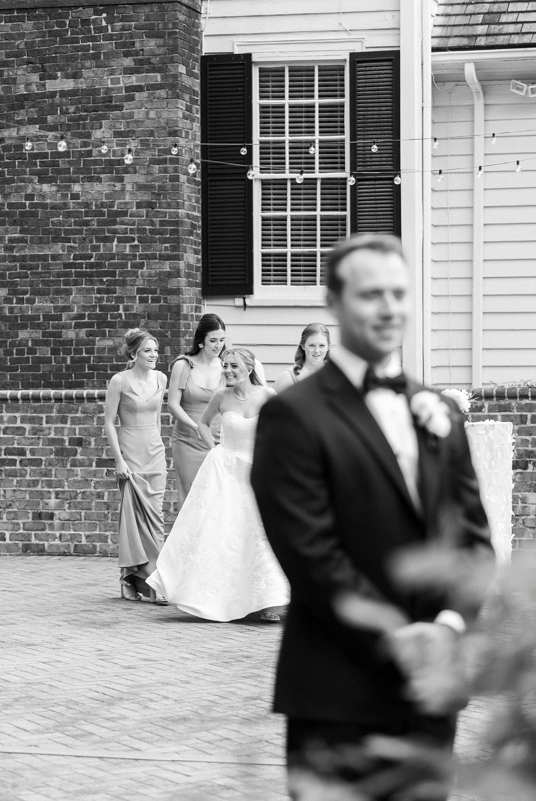 bridesmaids help bride walk to meet groom outside the Sutherland