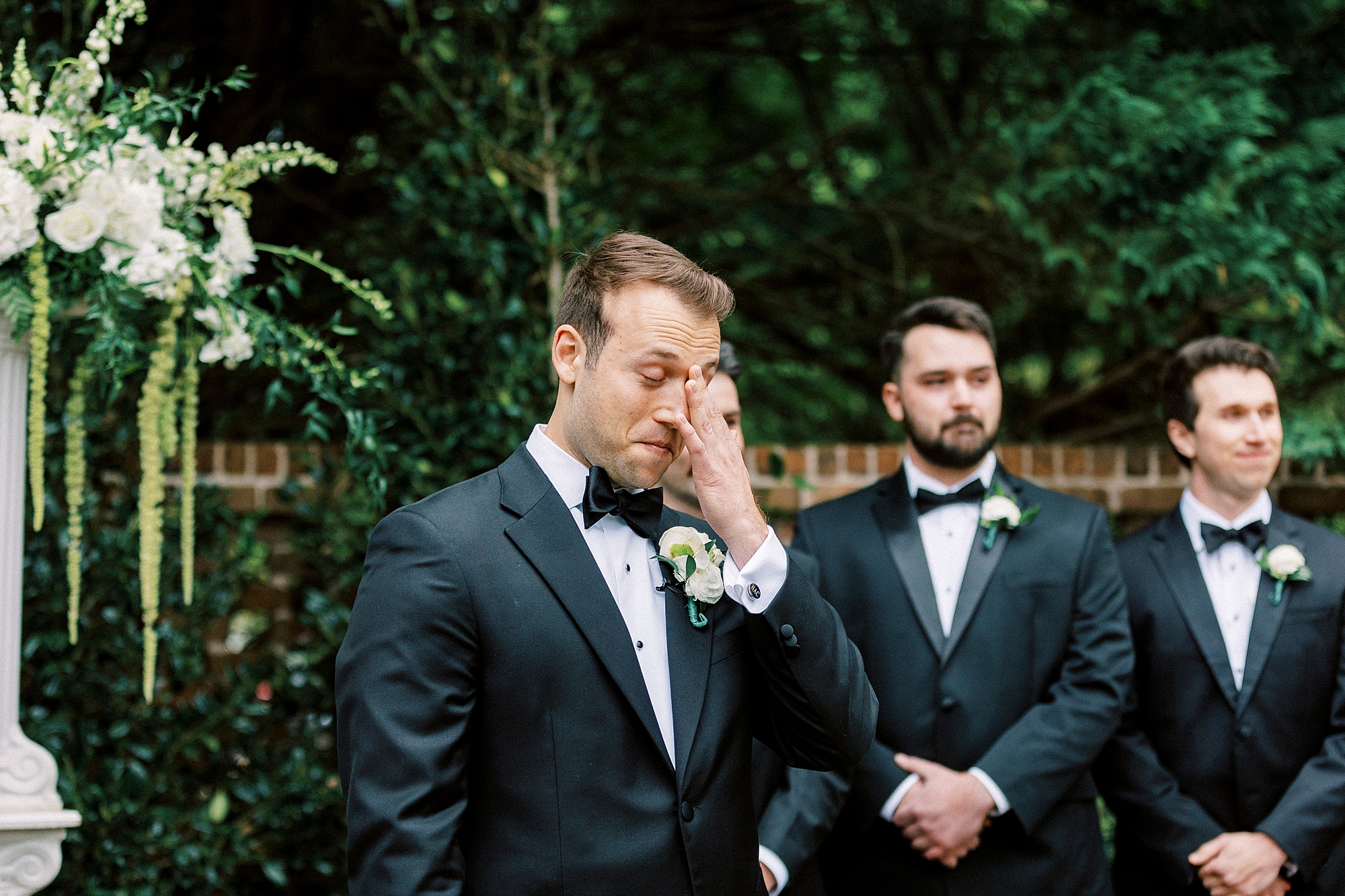 groom cries standing at alter during wedding ceremony 