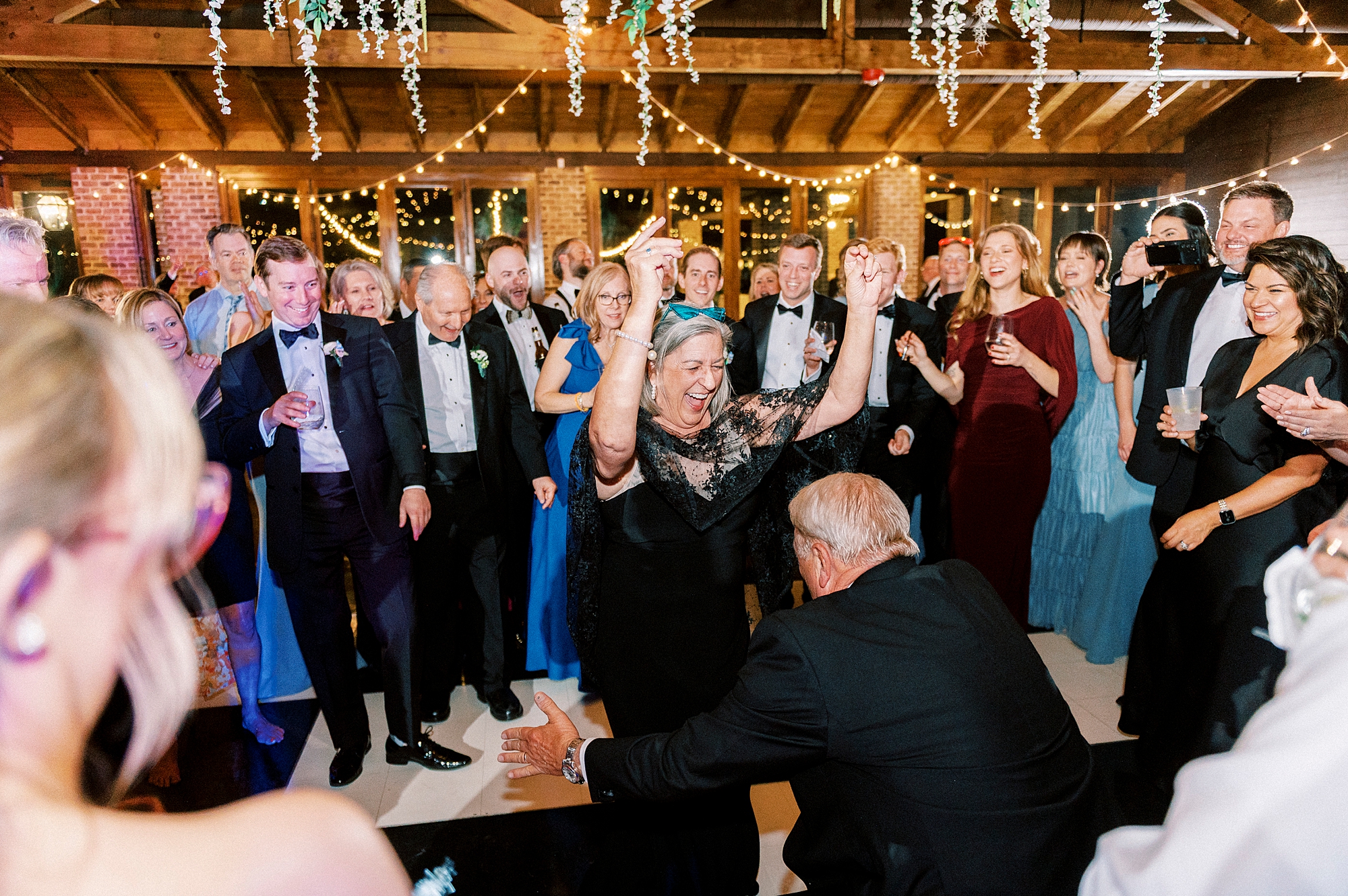 wedding guests dance during Wake Forest NC wedding reception in pavilion
