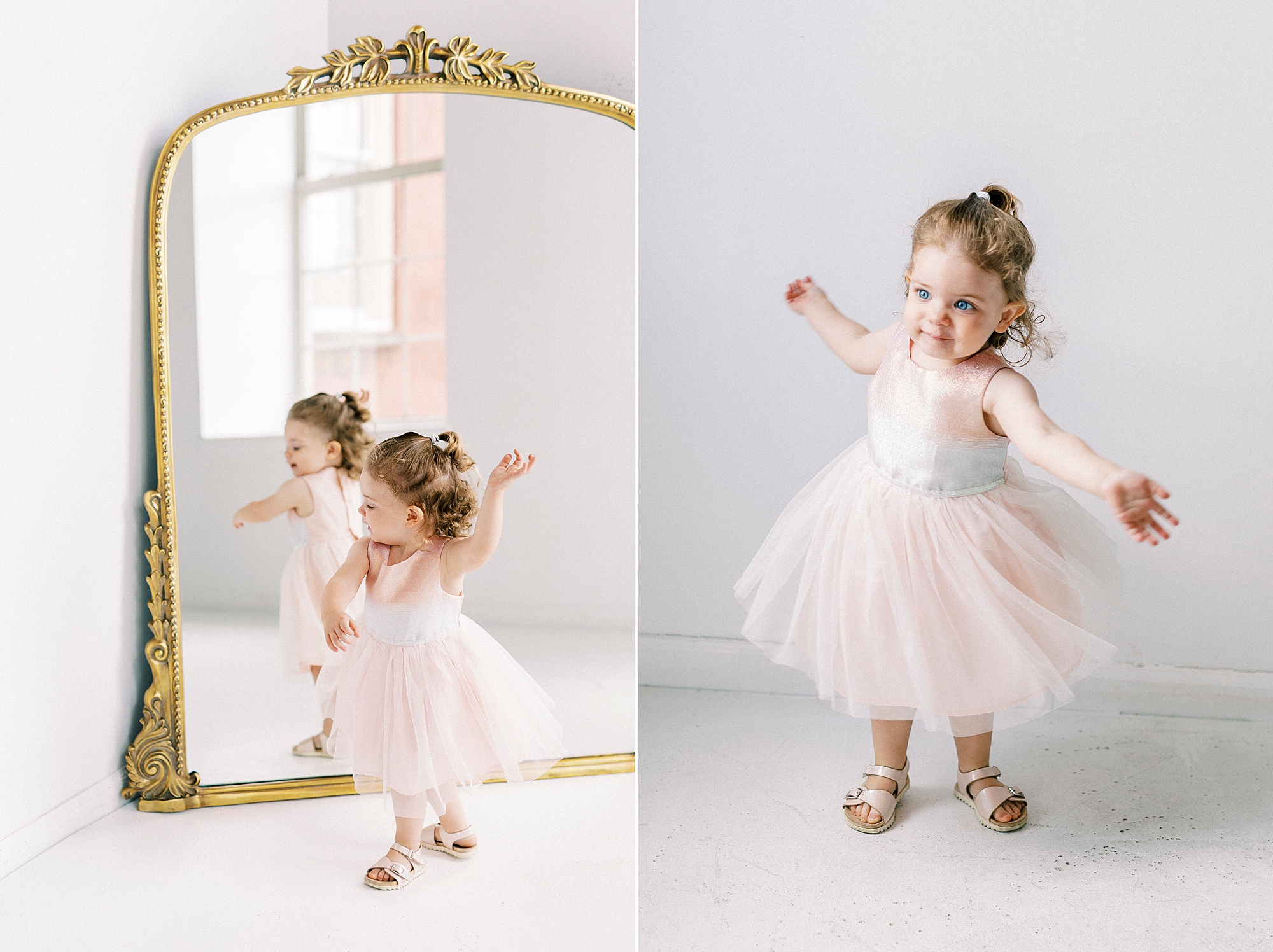 two year old twirls in front of gold rimmed mirror 