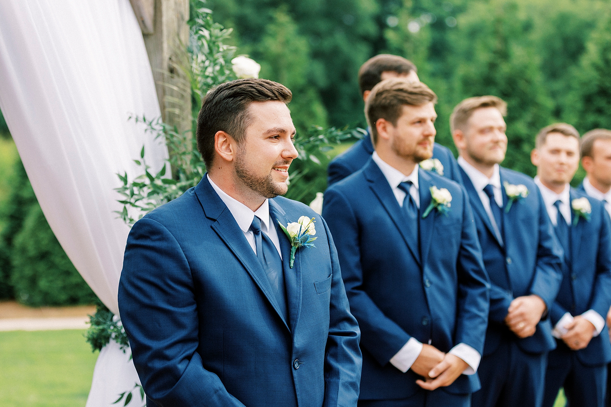 groom watches bride walk down aisle during ceremony at Low Meadows Estate