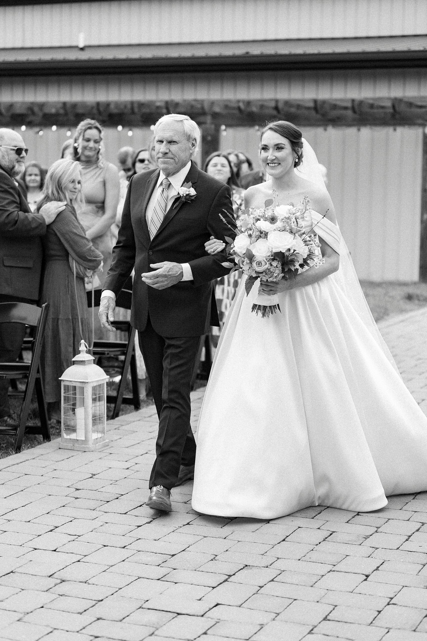 father escorts bride down aisle for wedding ceremony at Low Meadows Estate
