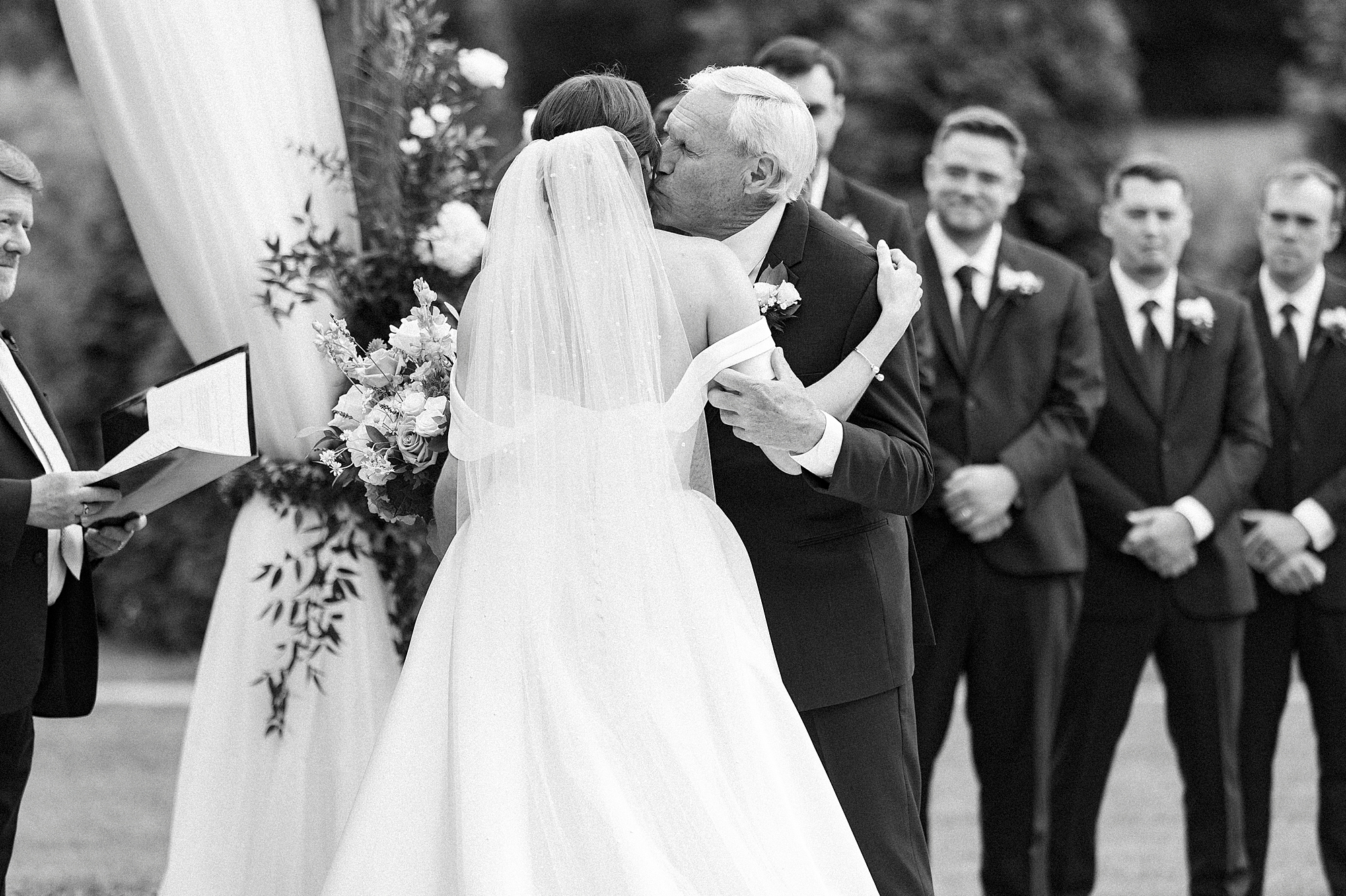 father kisses bride's cheek during wedding ceremony at Low Meadows Estate