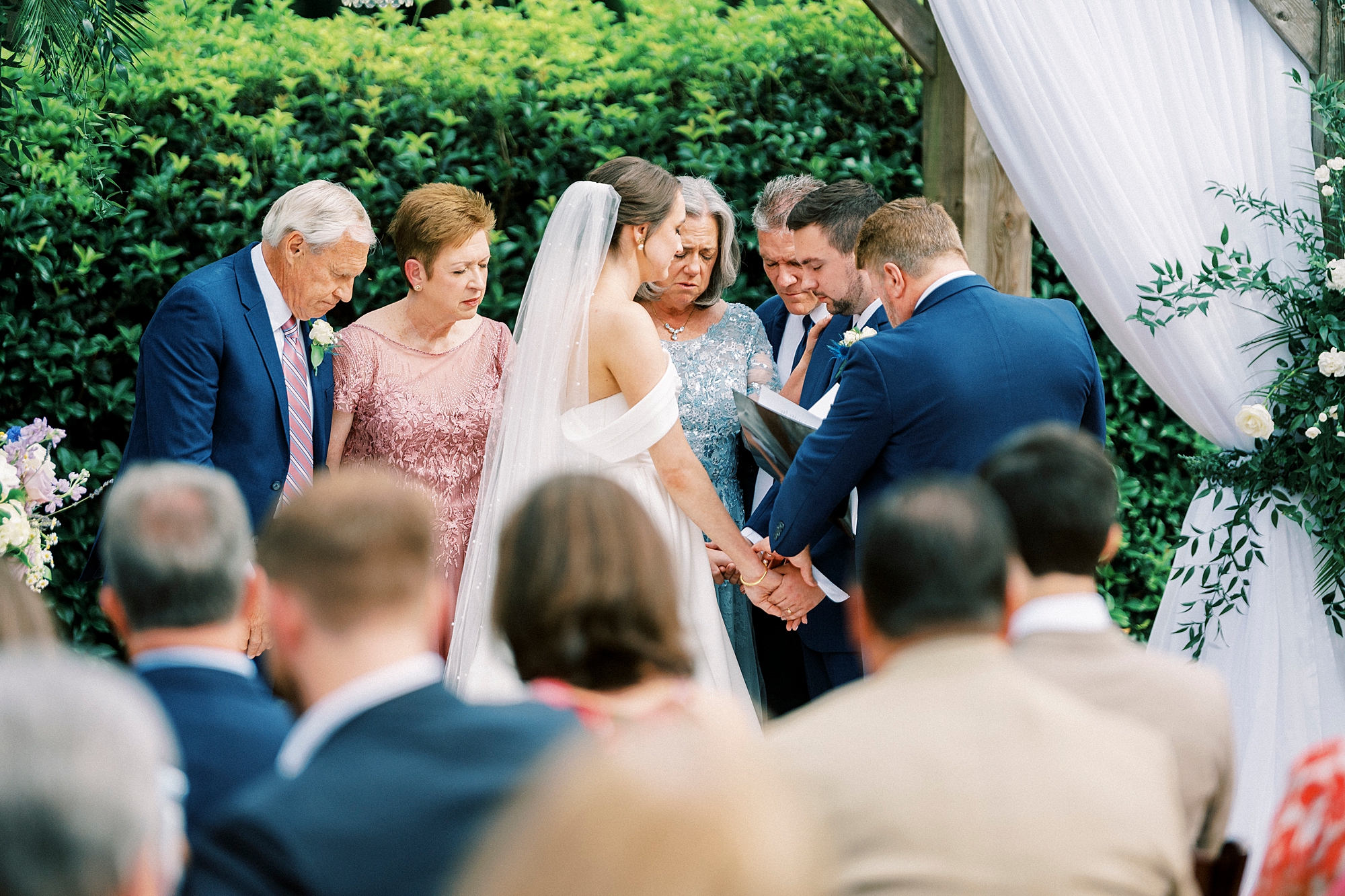 bride and groom pray with parents during wedding ceremony at Low Meadows Estate