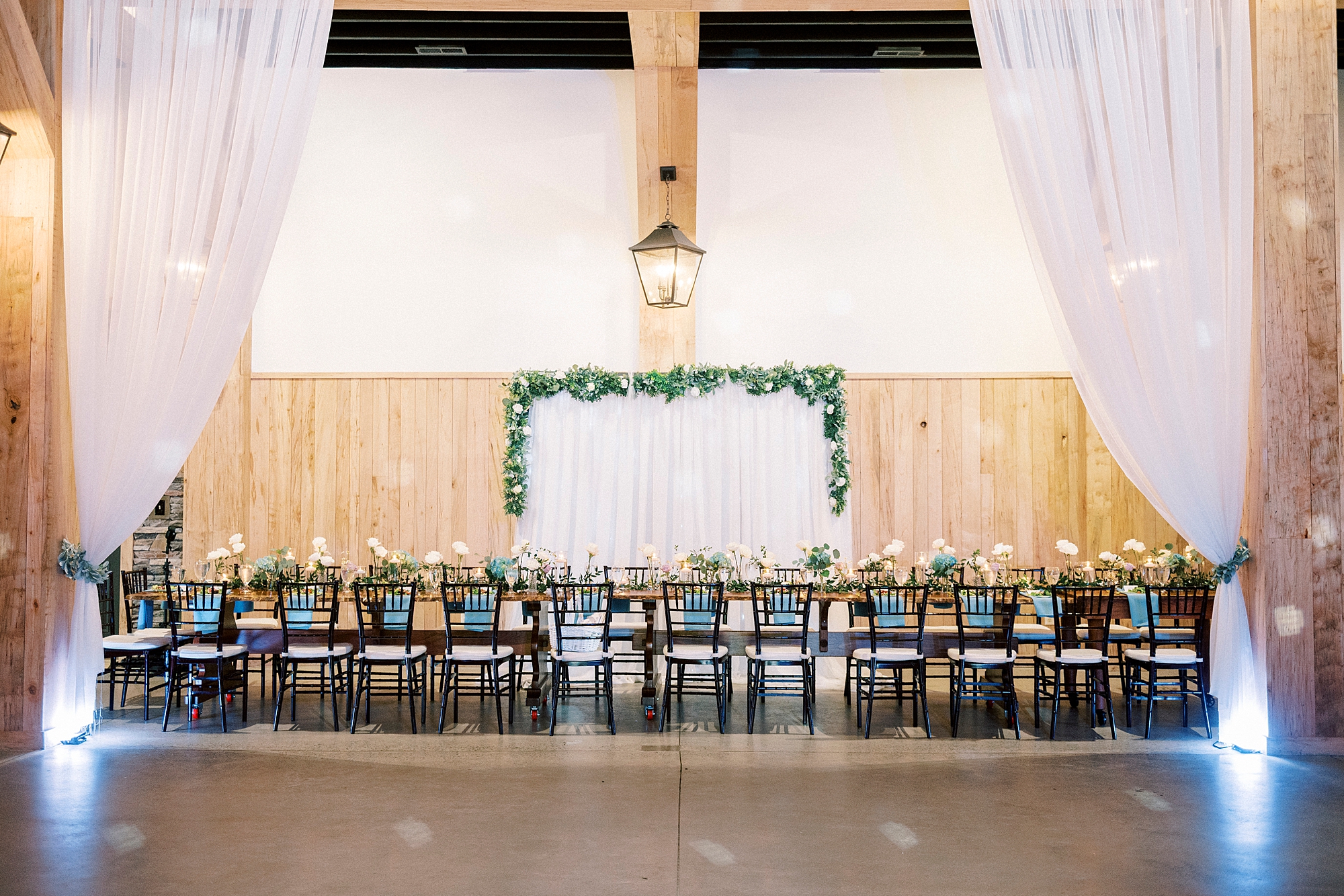wedding reception in barn with blue and white accents at Low Meadows Estate