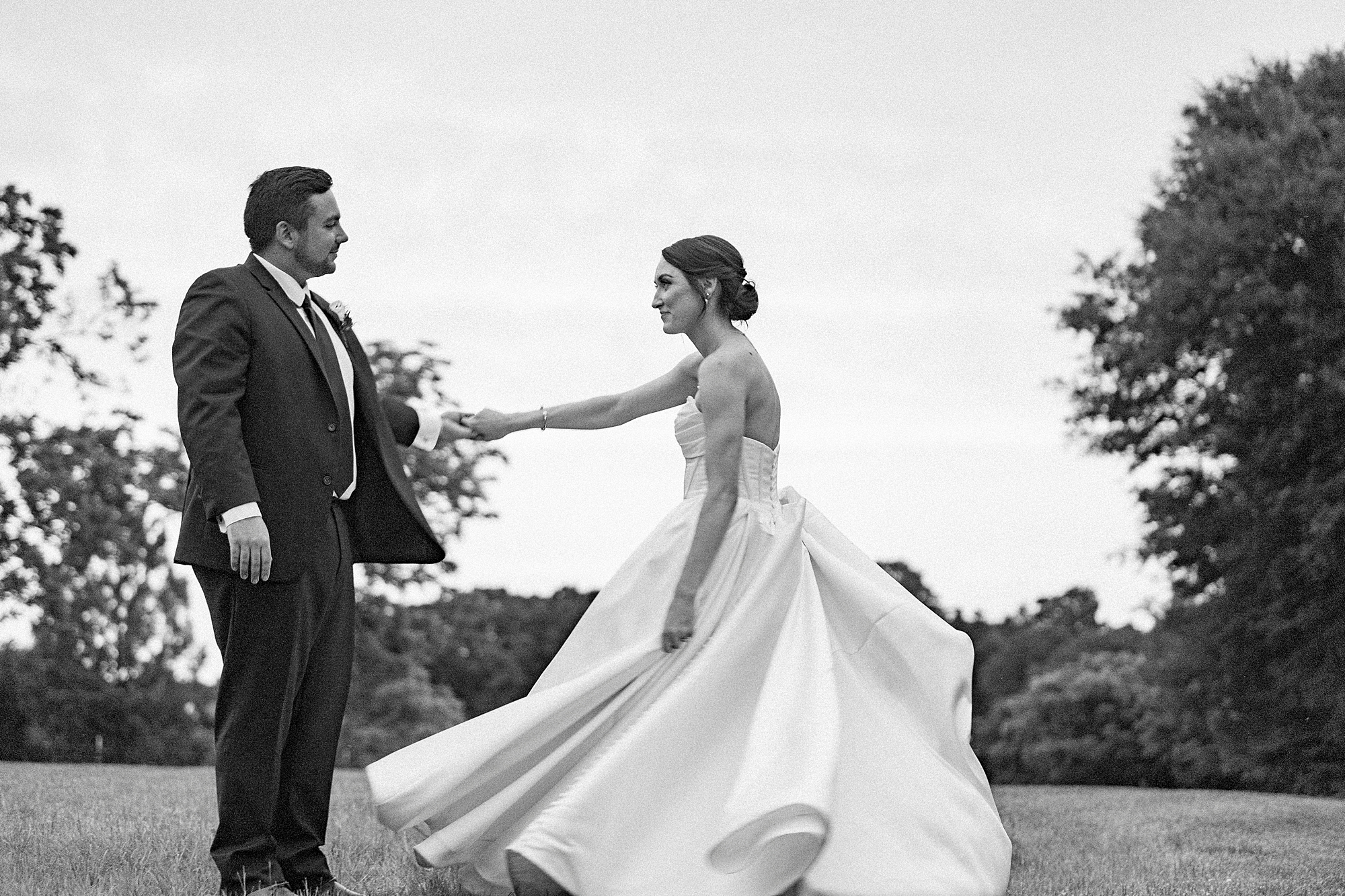 groom twirls bride on hill at Low Meadows Estate