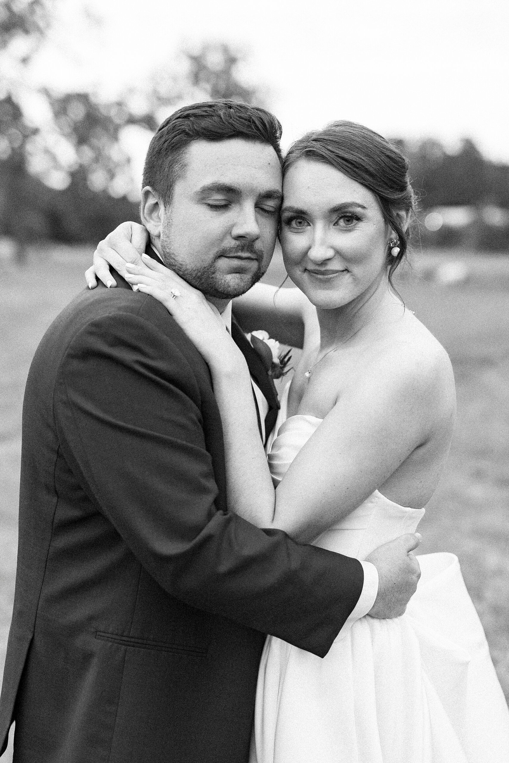 bride and groom hug leaning heads together 