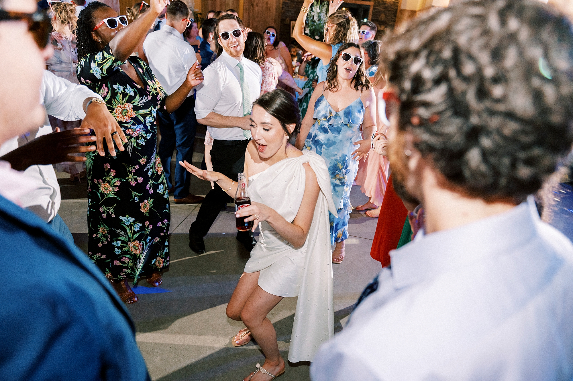 bride dances with guests during wedding reception in Belmont NC
