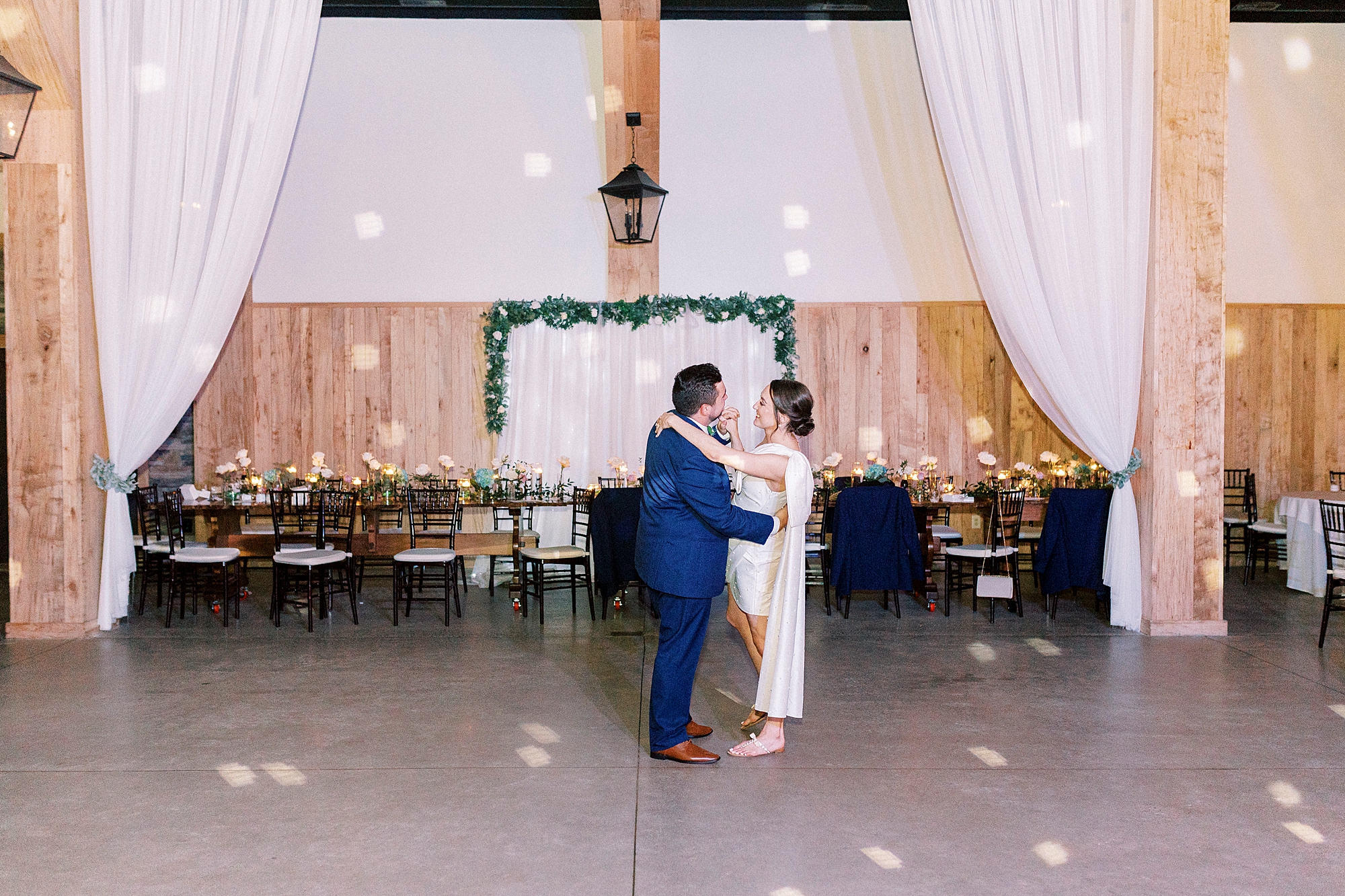 bride and groom dance during wedding reception in barn at Low Meadows Estate