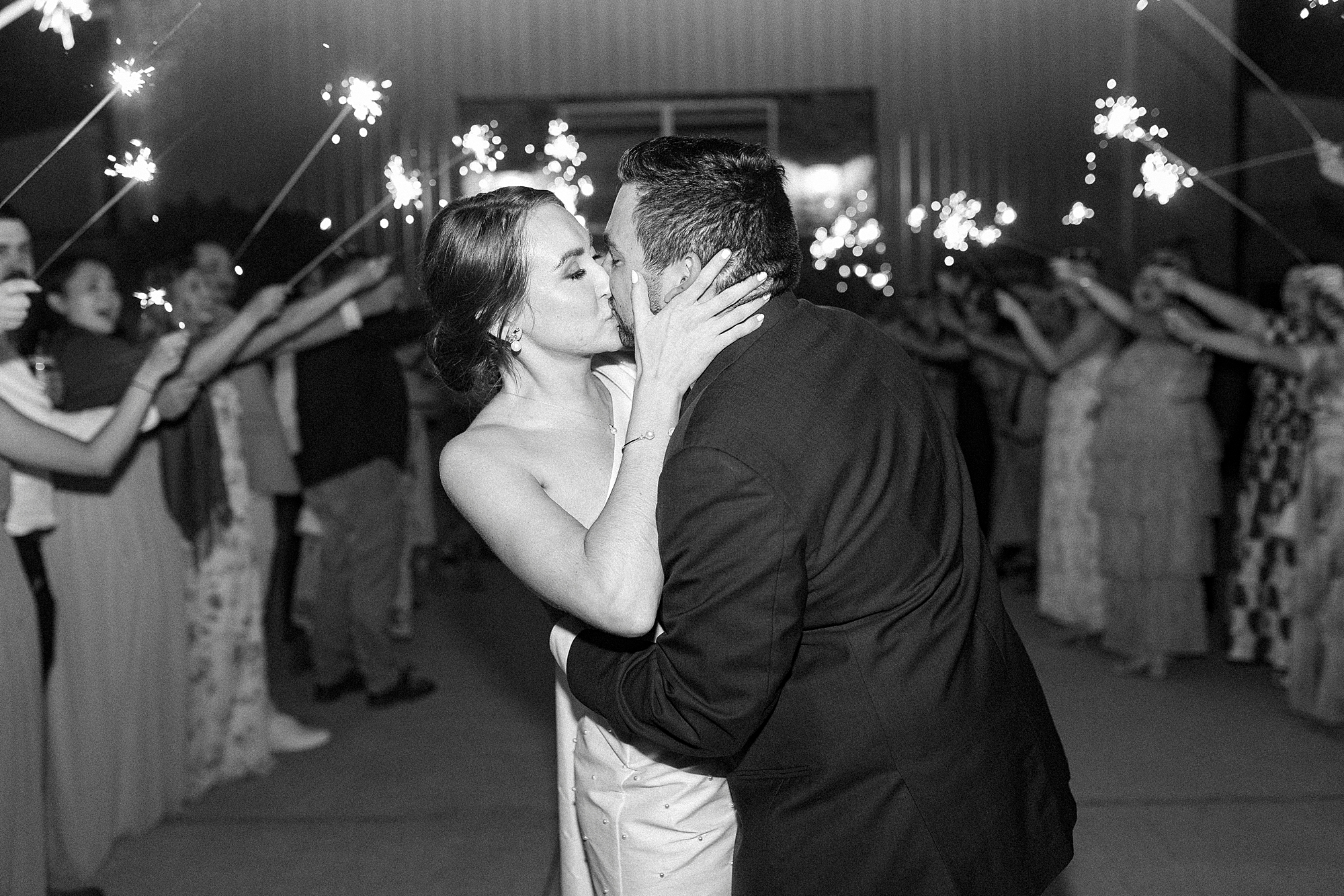 newlyweds kiss at end of sparkler exit 